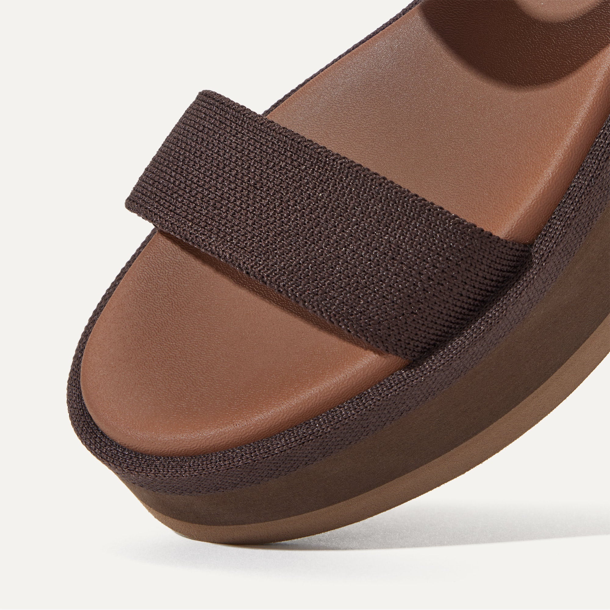 Close up of the knit rand of The Lightweight Wedge Sandal in Cardamom, shown in diagonal view. 
