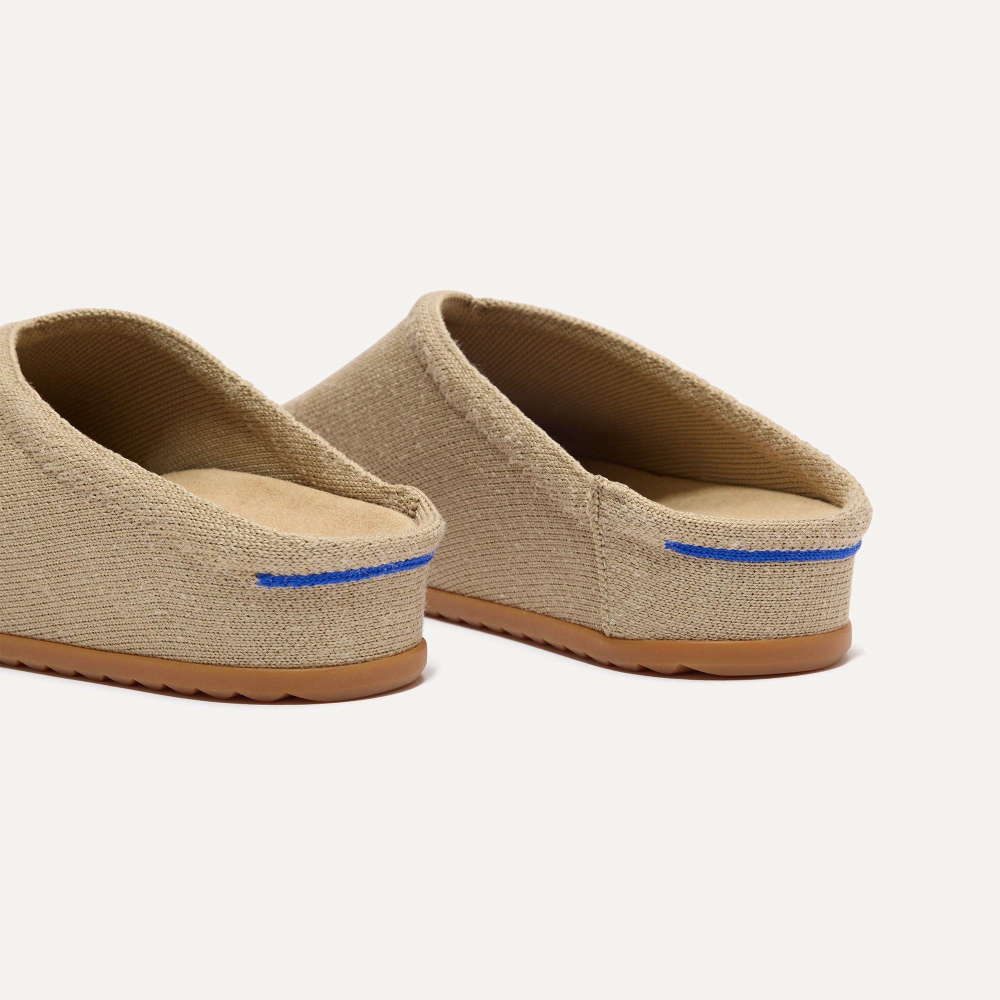 Close up of the heel of The Casual Clog in Dune, with Rothy's signature blue halo. 