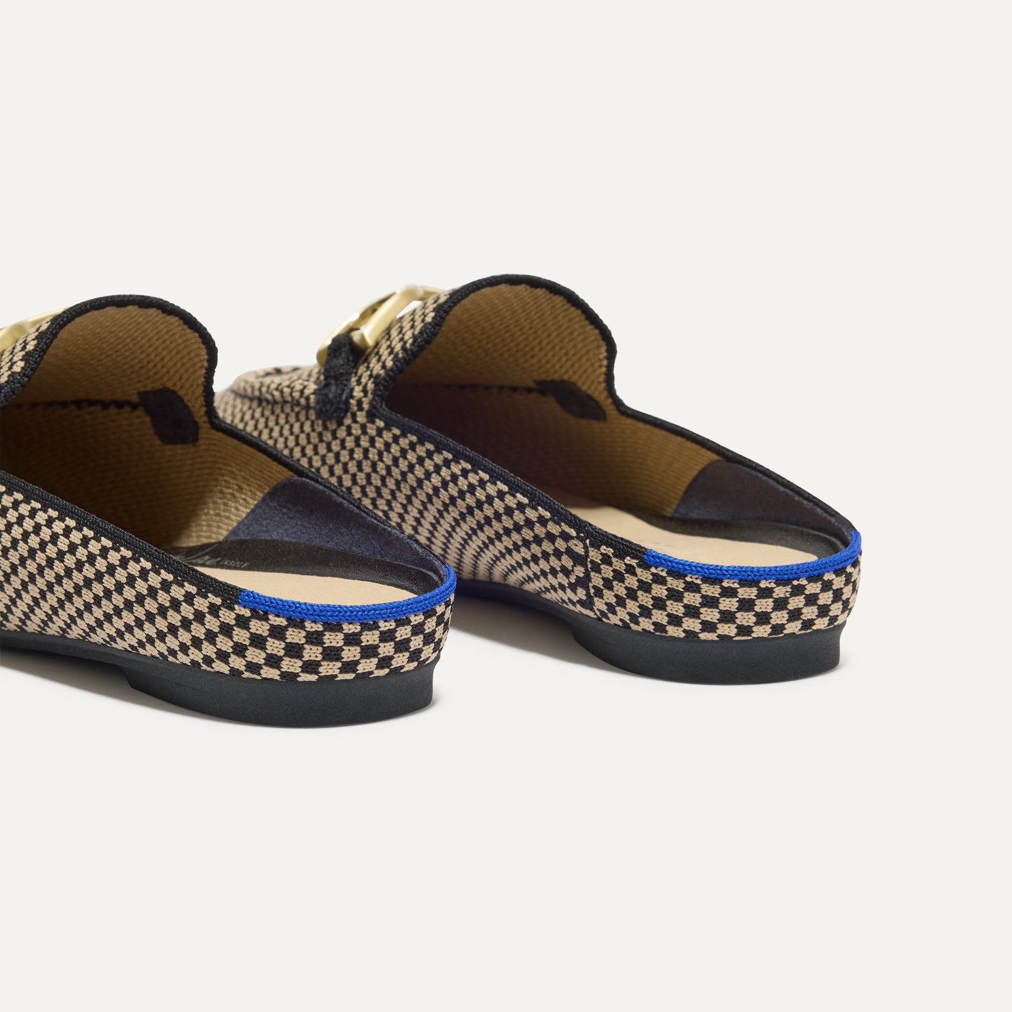 Close up of the heel of The Double Bit Loafer Mule in Classic Micro Check, with Rothy's signature blue halo. 