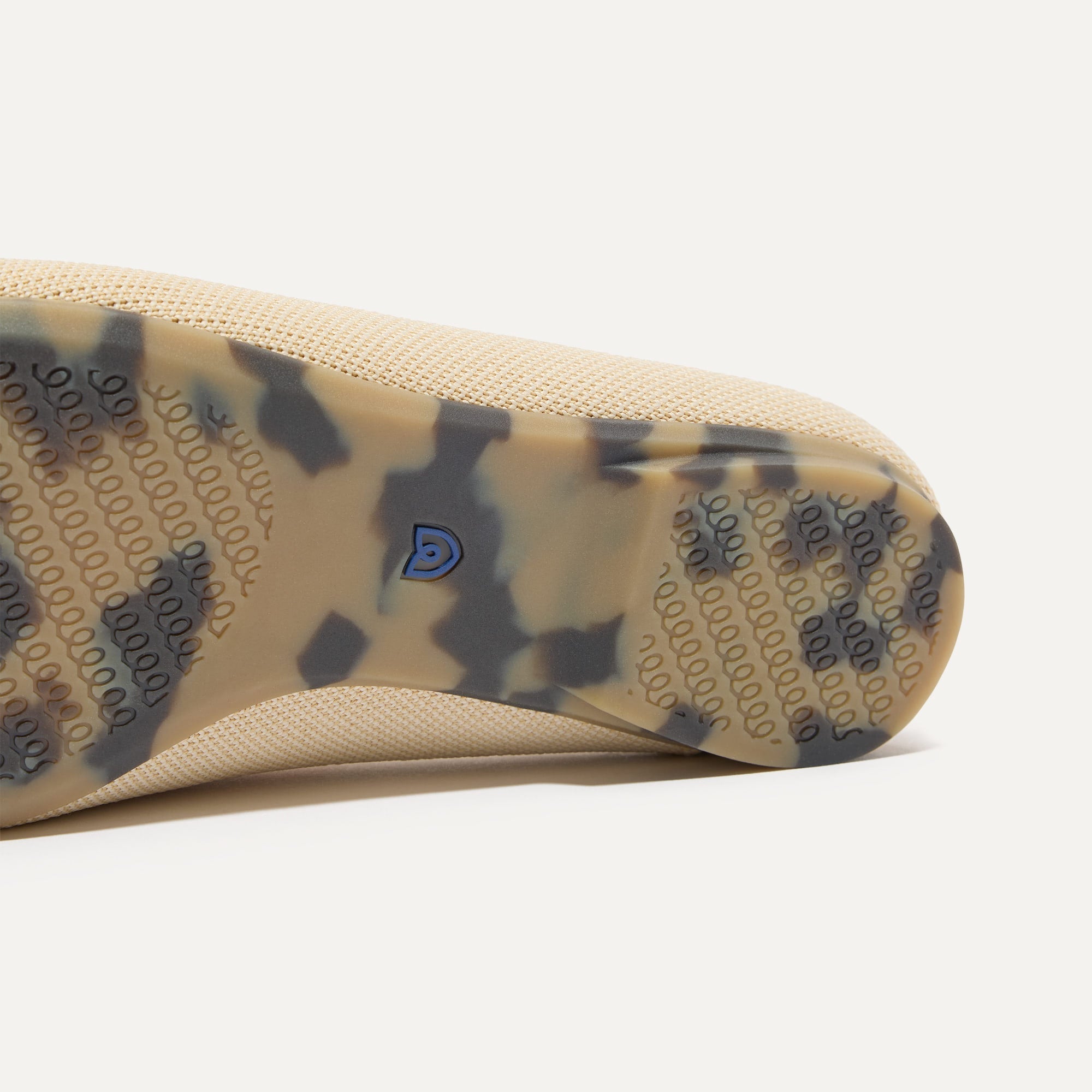 Close up of the outsoles of The Double Bit Loafer Mule in Sandstone.