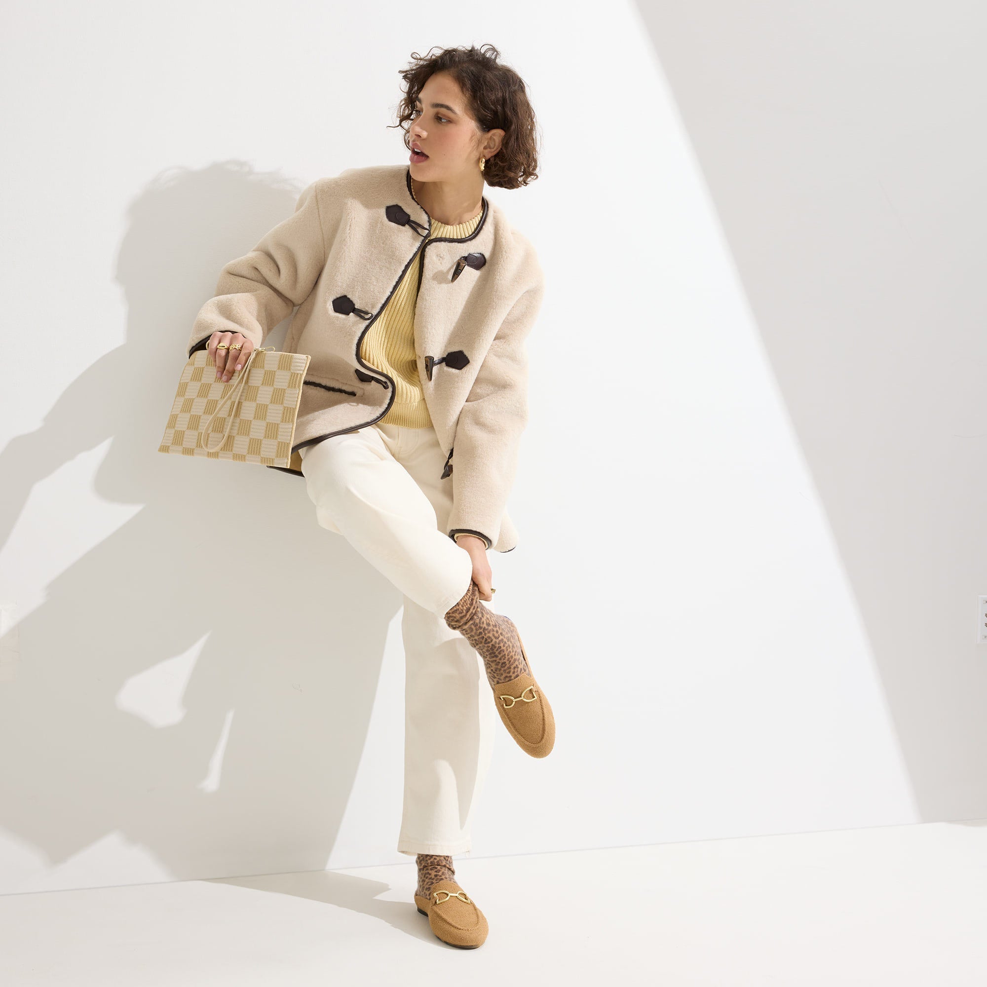 hover | Model holding The Wristlet in Checker Sand.