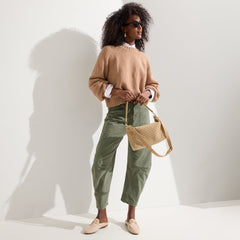 The Daily Crossbody in Golden Sun, carried over the shoulder of a female model, shown from the right.