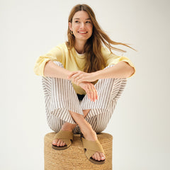 Alternate view of a model wearing The Weekend Slide in Golden Sun.