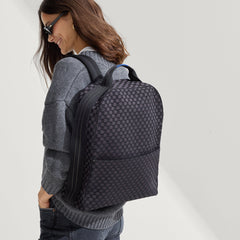 hover | Model wearing The Backpack in Black Sand on her back.