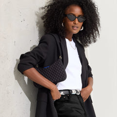 hover | Model holding The Mini Shoulder Bag in Black Sand.