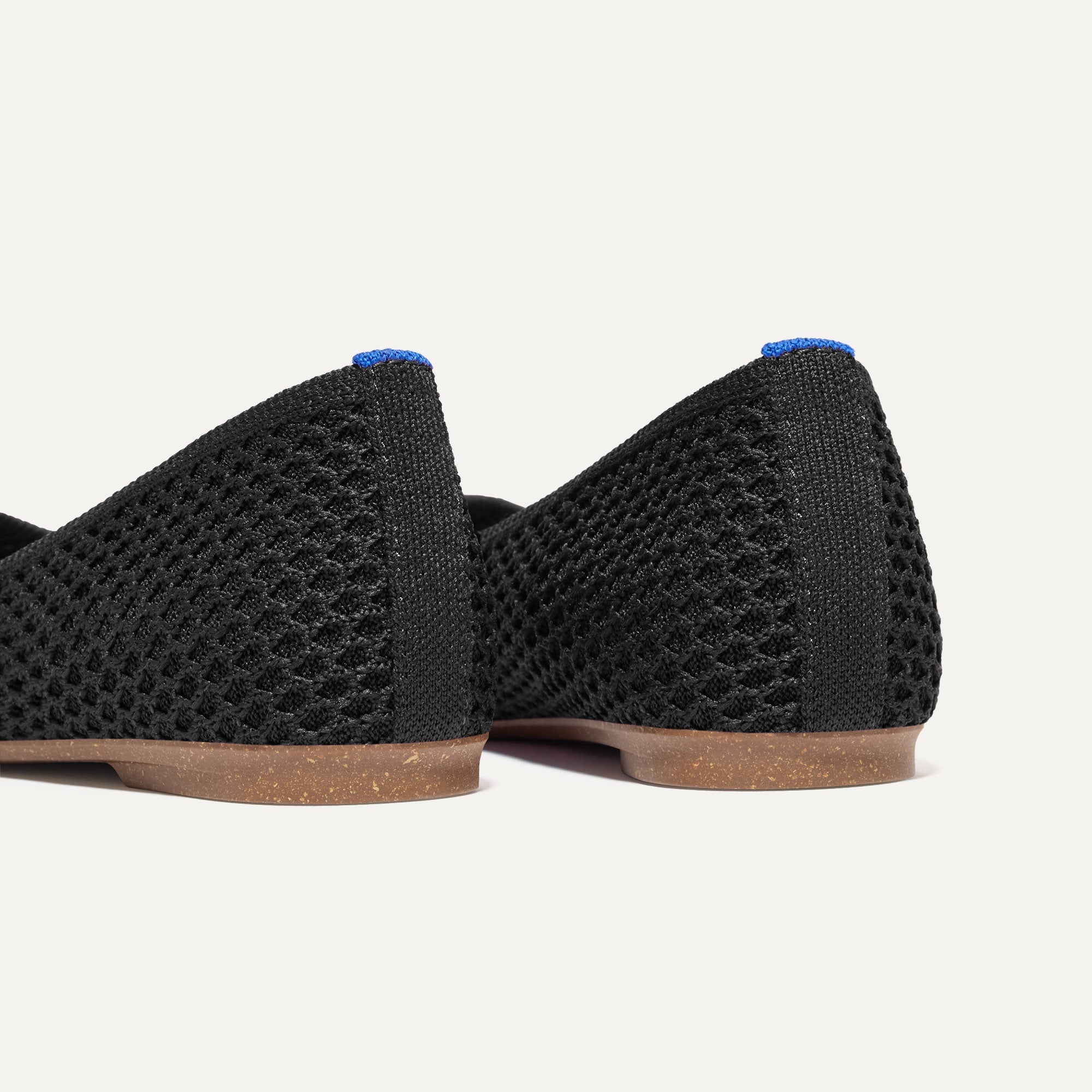 Close up of the heel of The Max Square in Black Mesh with Rothy's signature blue halo.