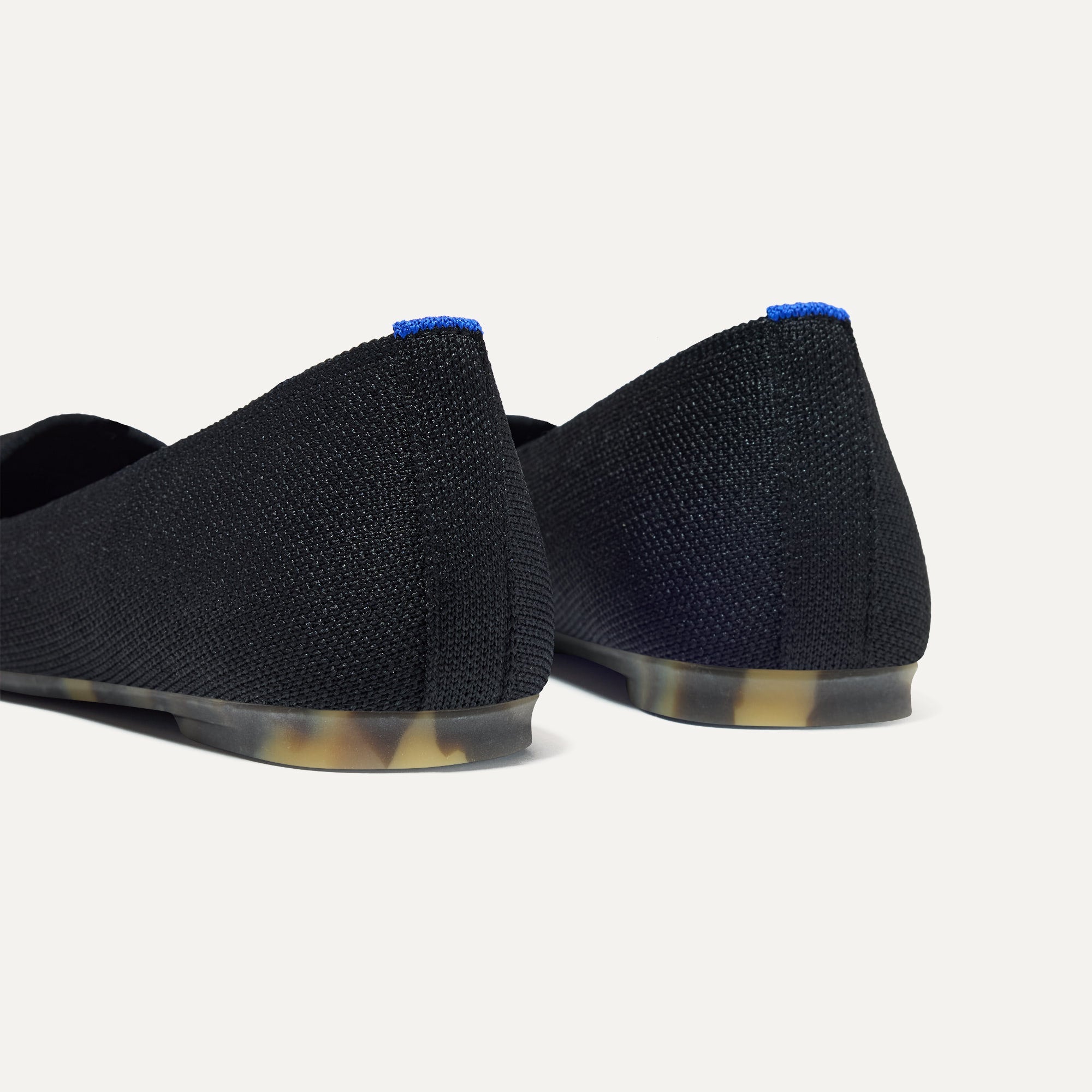 Close up of the heel of The Max Square in Black with Rothy's signature blue halo.