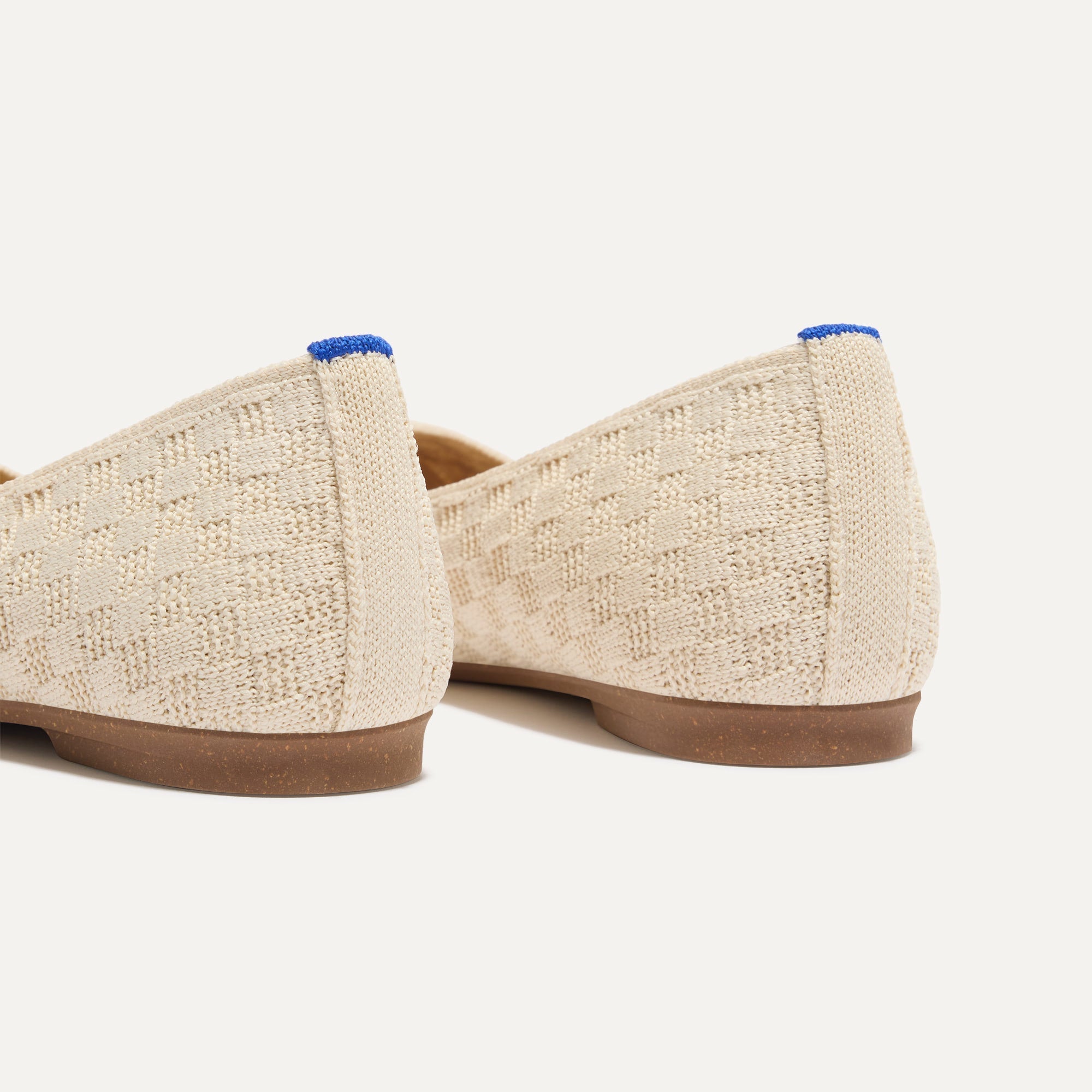 Close up of the heel of The Max Square in Conch with Rothy's signature blue halo.