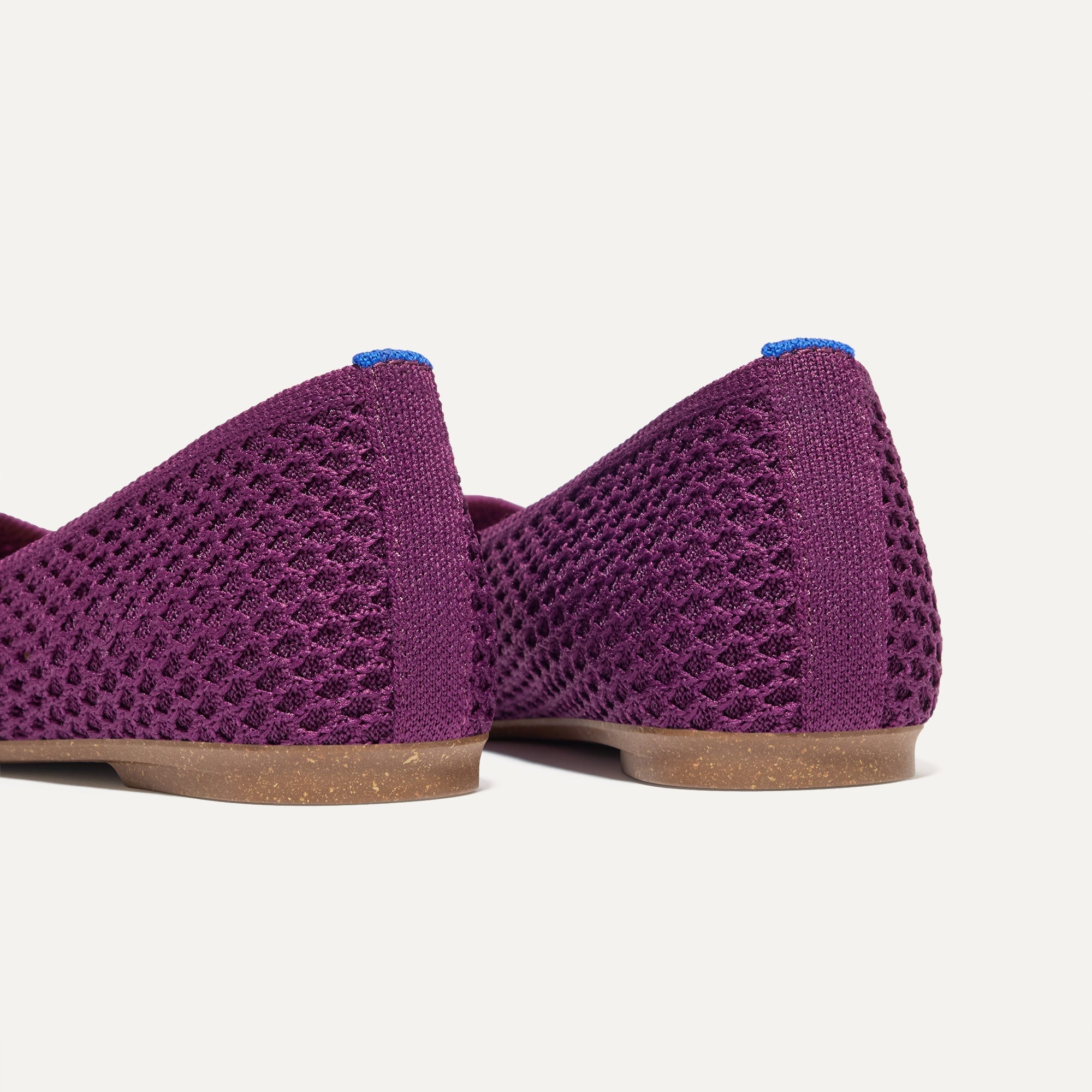 Close up of the heel of The Max Square in Plum Mesh with Rothy's signature blue halo.