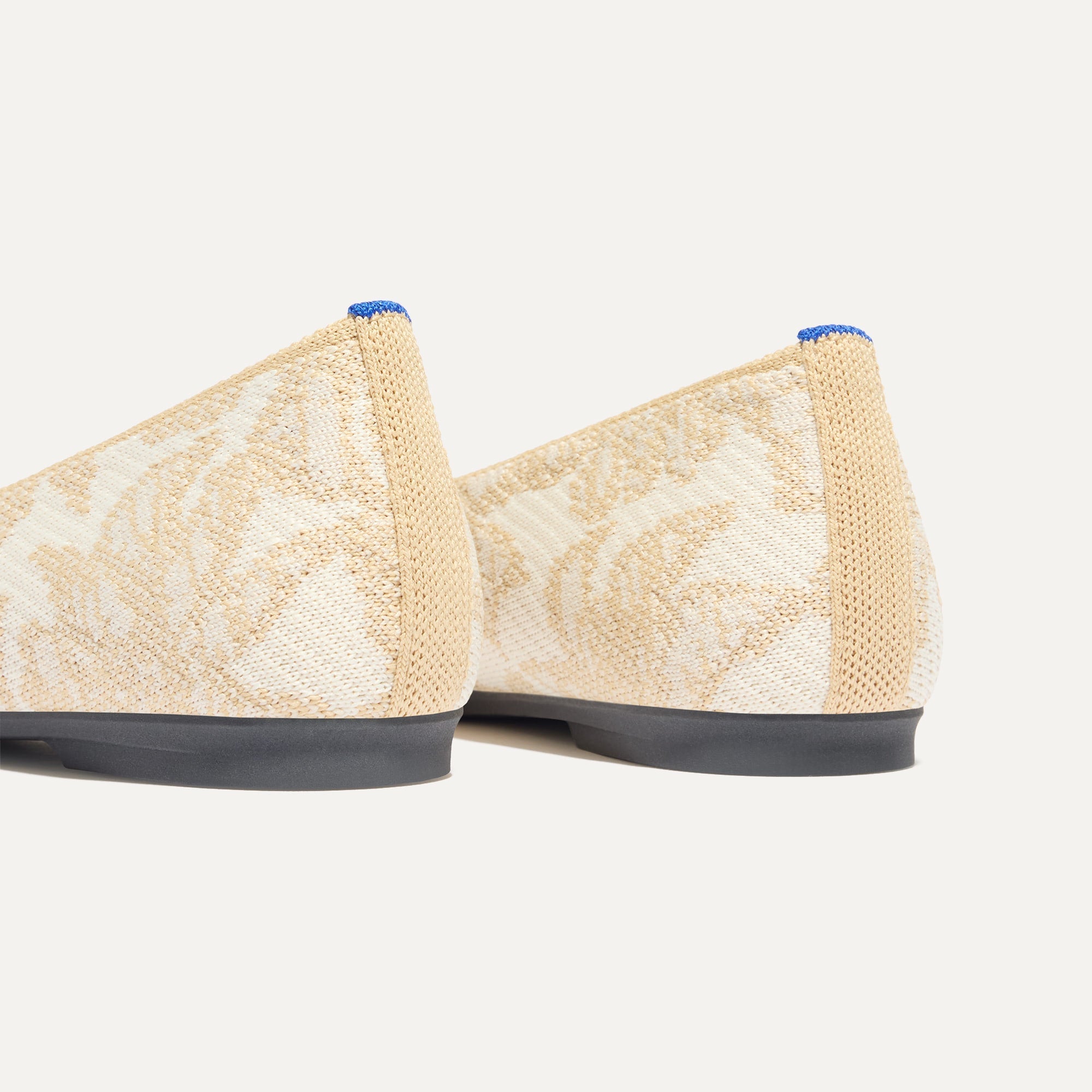 Close up of the heel of The Max Square in White Chantilly with Rothy's signature blue halo.