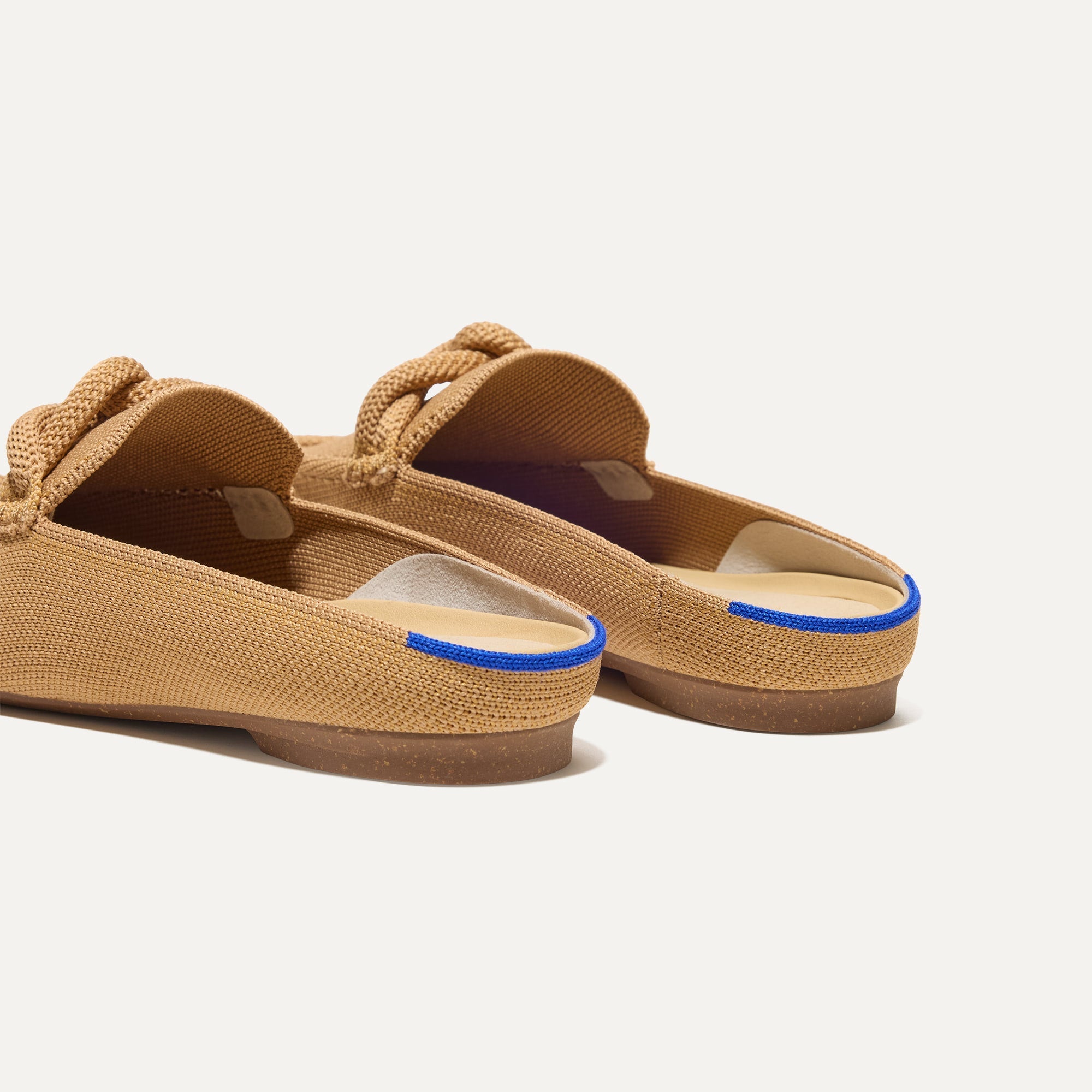 Close up of the heel of The Loafer Mule in Wren Birdseye, with Rothy's signature blue halo.