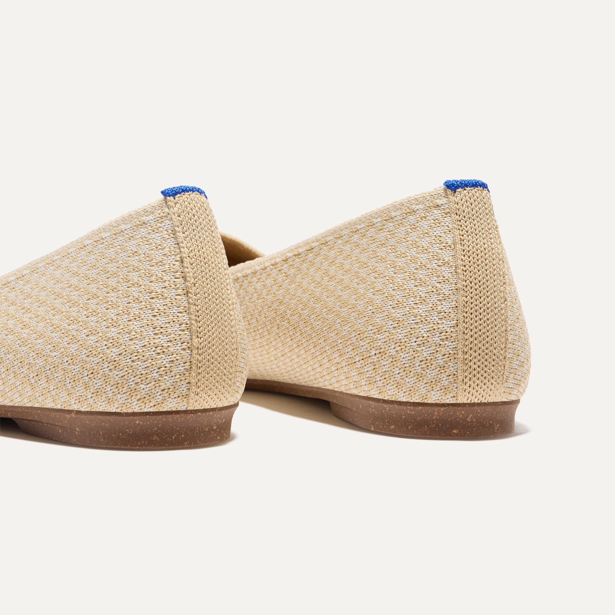 Close up of the heel of The Max Square in Sandstone Micro Check with Rothy's signature blue halo.