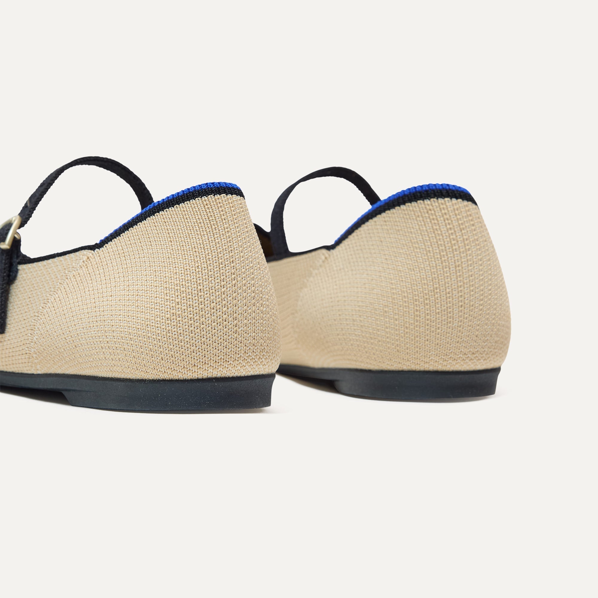 Close up of the heel of The Point Mary Jane II in Sandstone, with Rothy's signature blue halo.