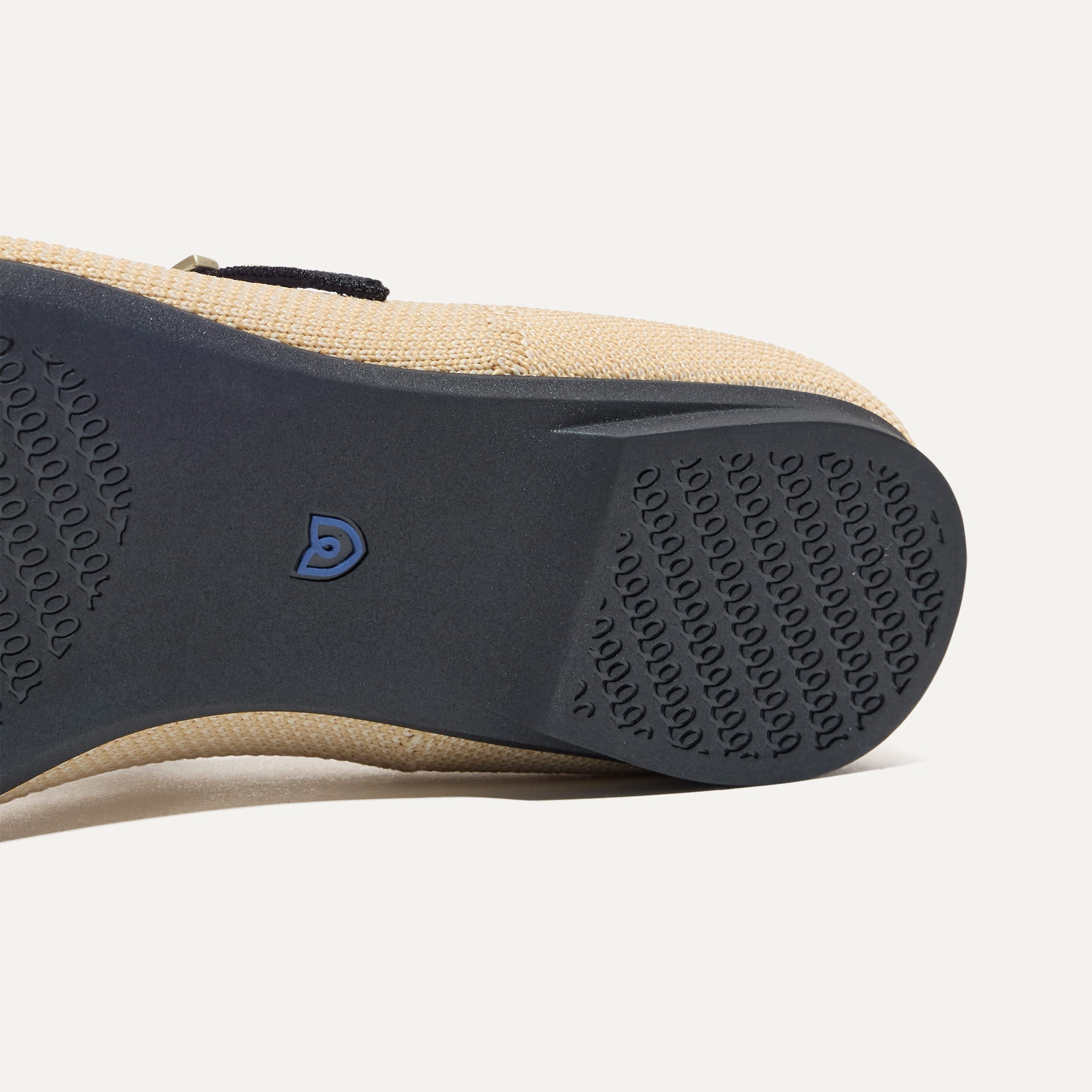 The sole of The Point Mary Jane II in Sandstone shown in diagonal view.