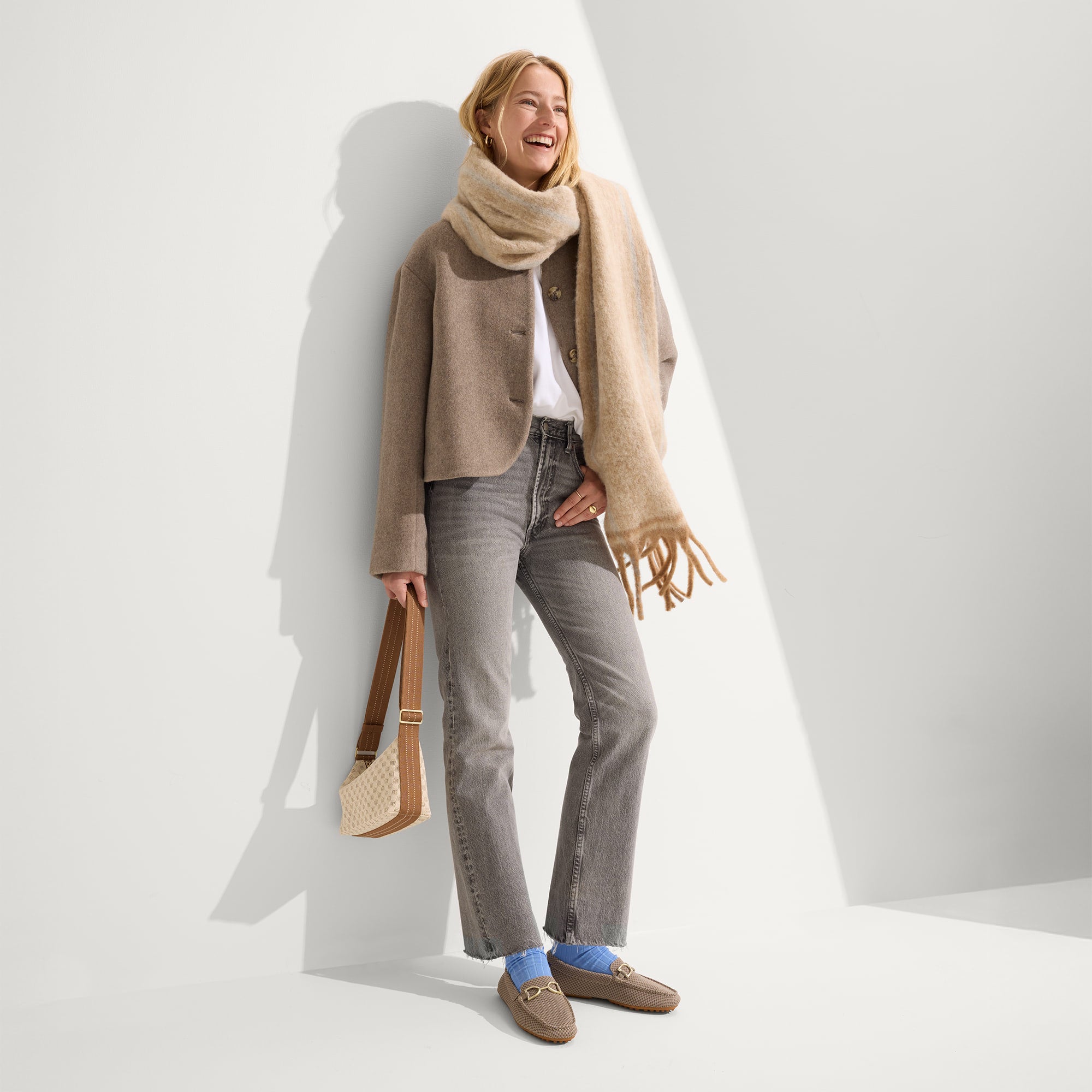 Alternate view of a model wearing The Double Bit Driver in Latte Micro Check.