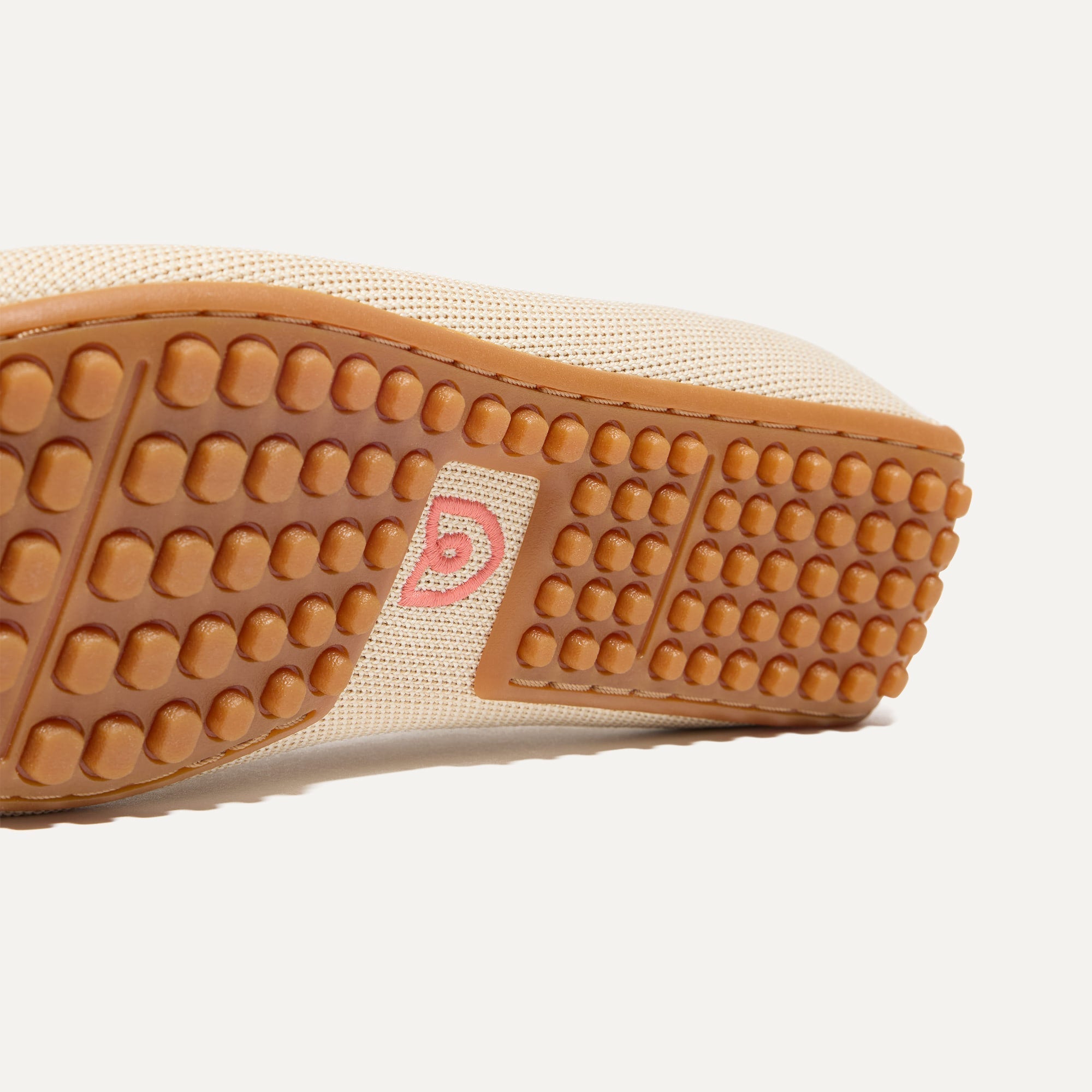 Close up of the raised nub outsoles of The Double Bit Driver in Sesame.