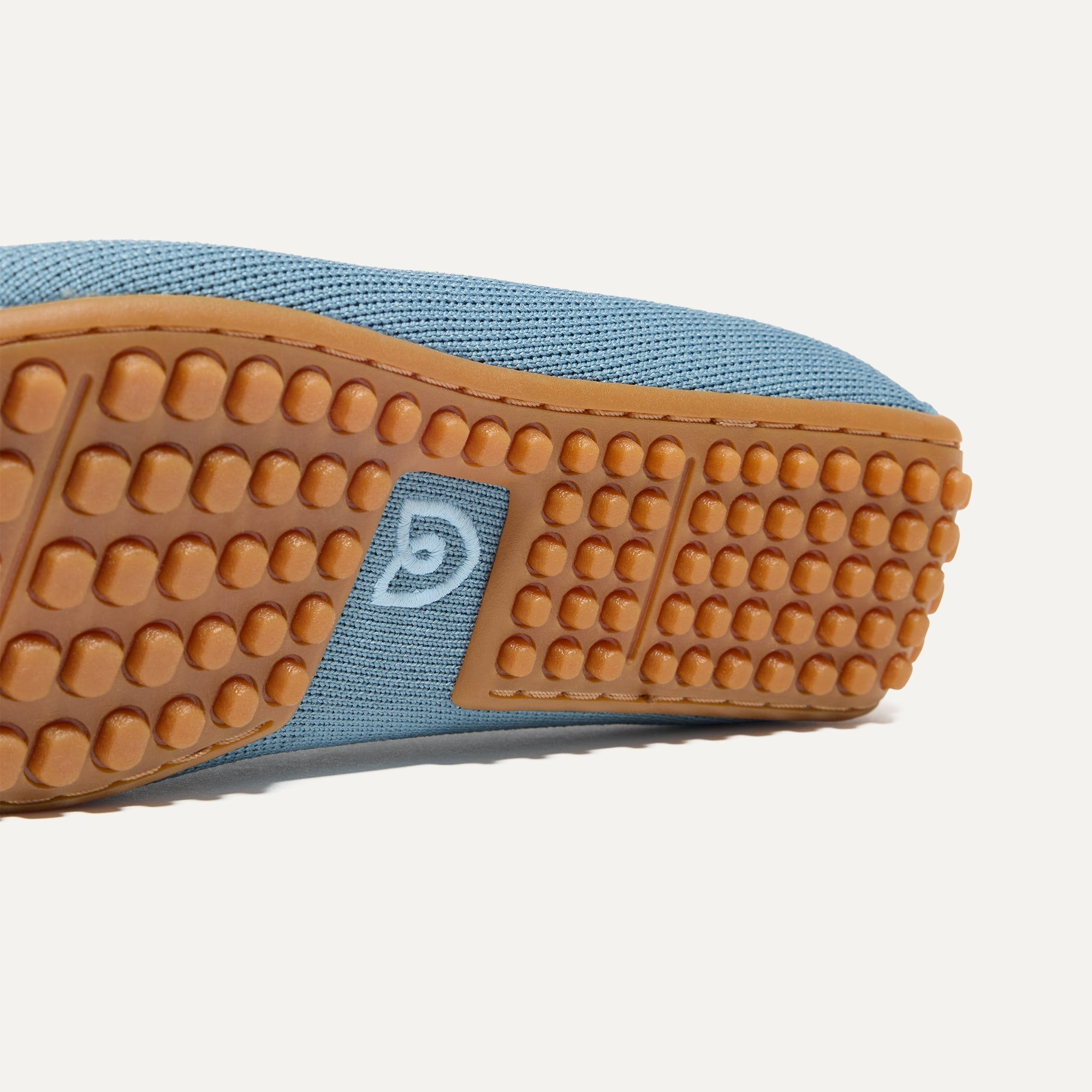 Close up of the raised nub outsoles of The Double Bit Driver in Sky.