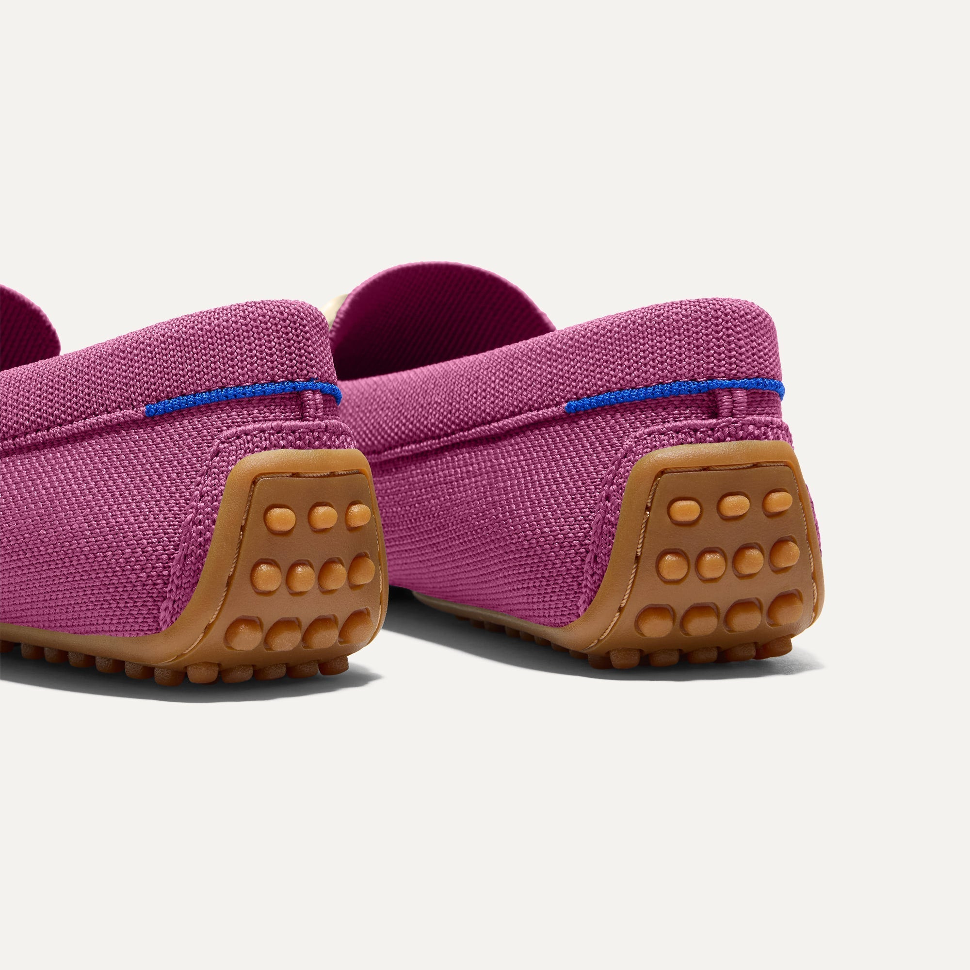 Close up of the heel of The Double Bit Driver in Taffy Pink, with raised nub outsoles and Rothy's signature blue halo. 