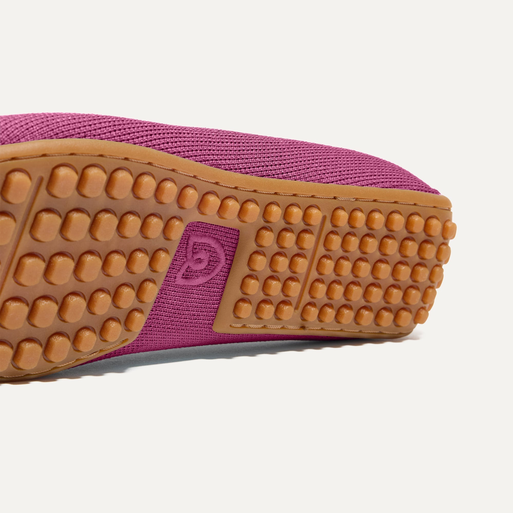 Close up of the raised nub outsoles of The Double Bit Driver in Taffy Pink.