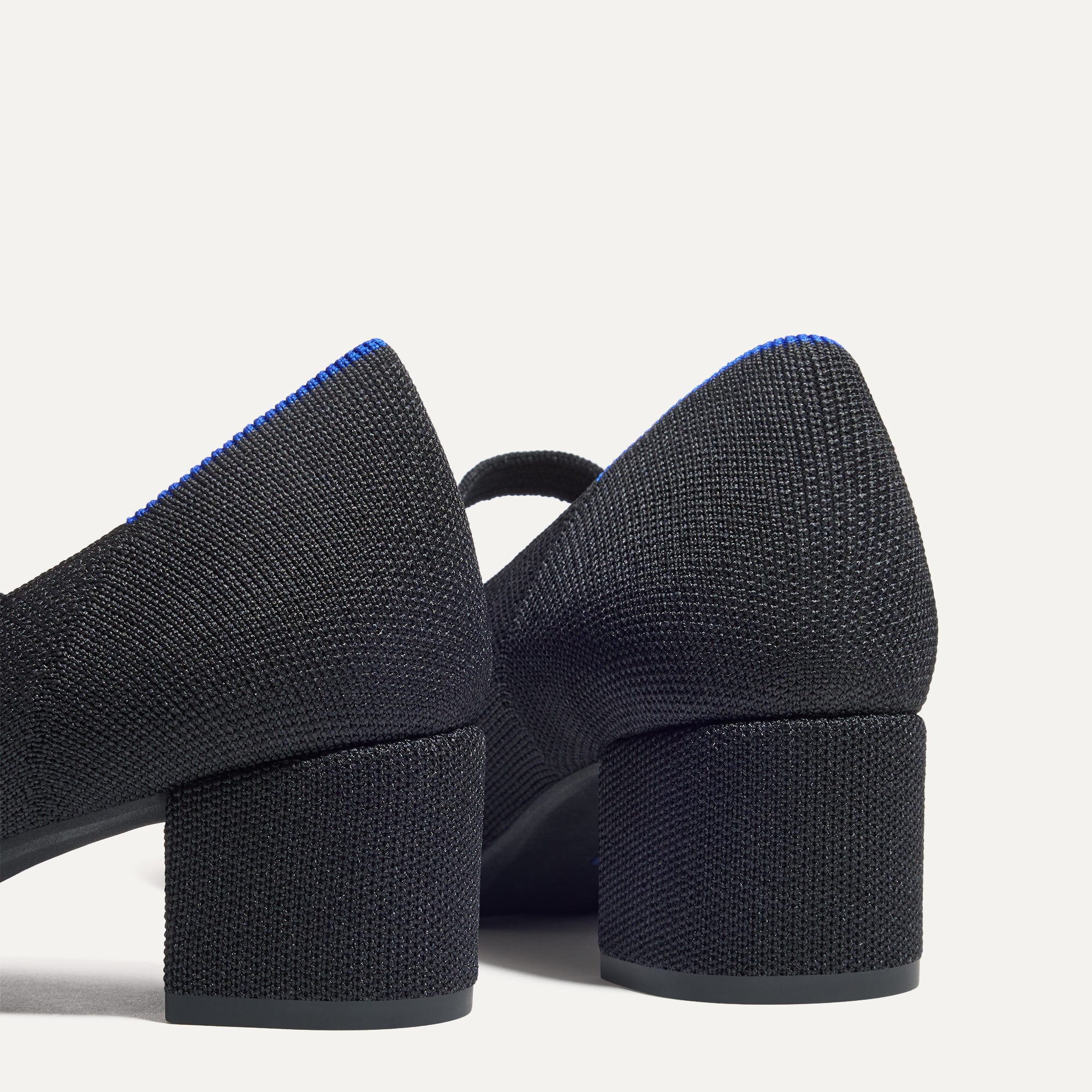 Close up of the heel of The Mary Jane Heel in Black, with Rothy's signature blue halo.