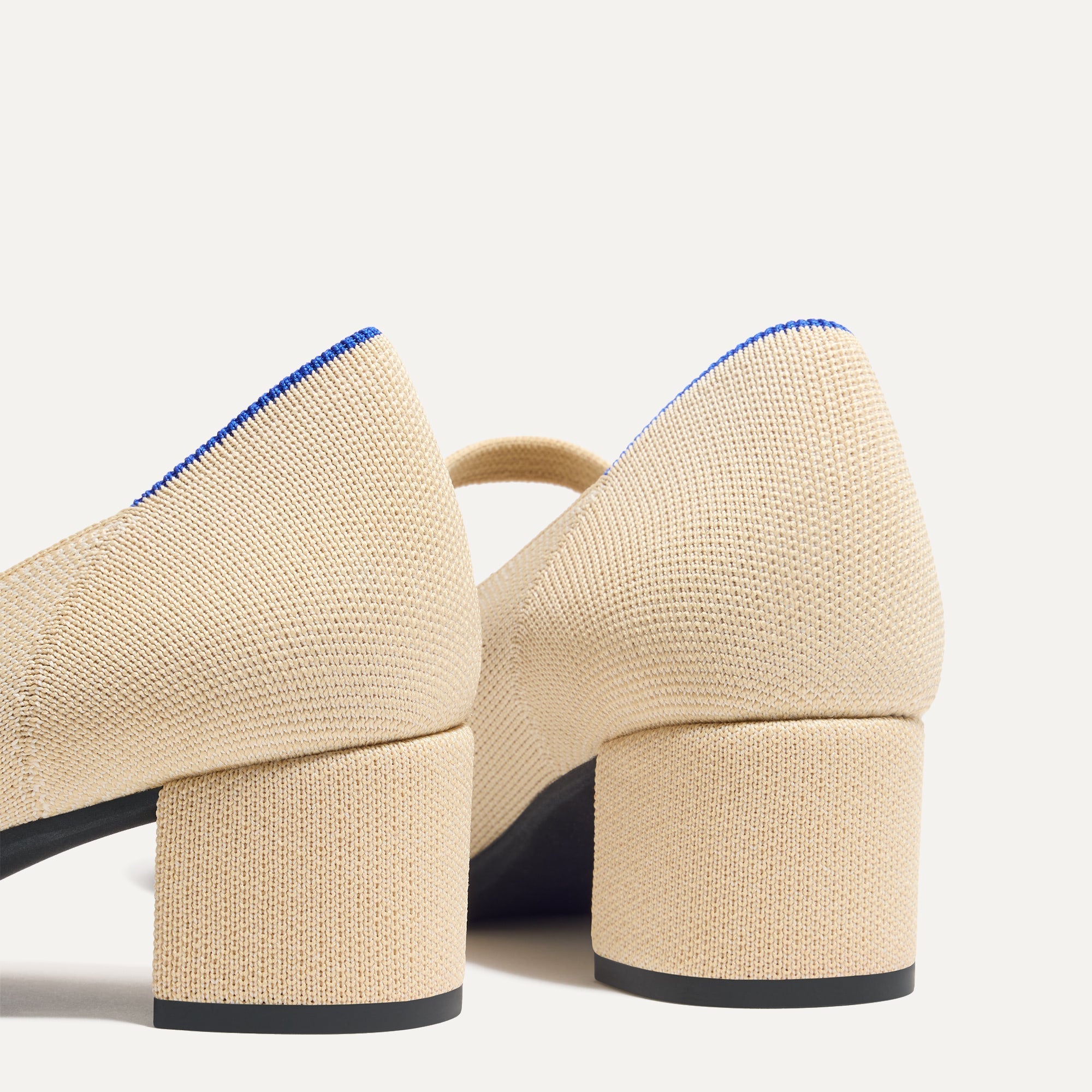 Close up of the heel of The Mary Jane Heel in Cream Captoe, with Rothy's signature blue halo.