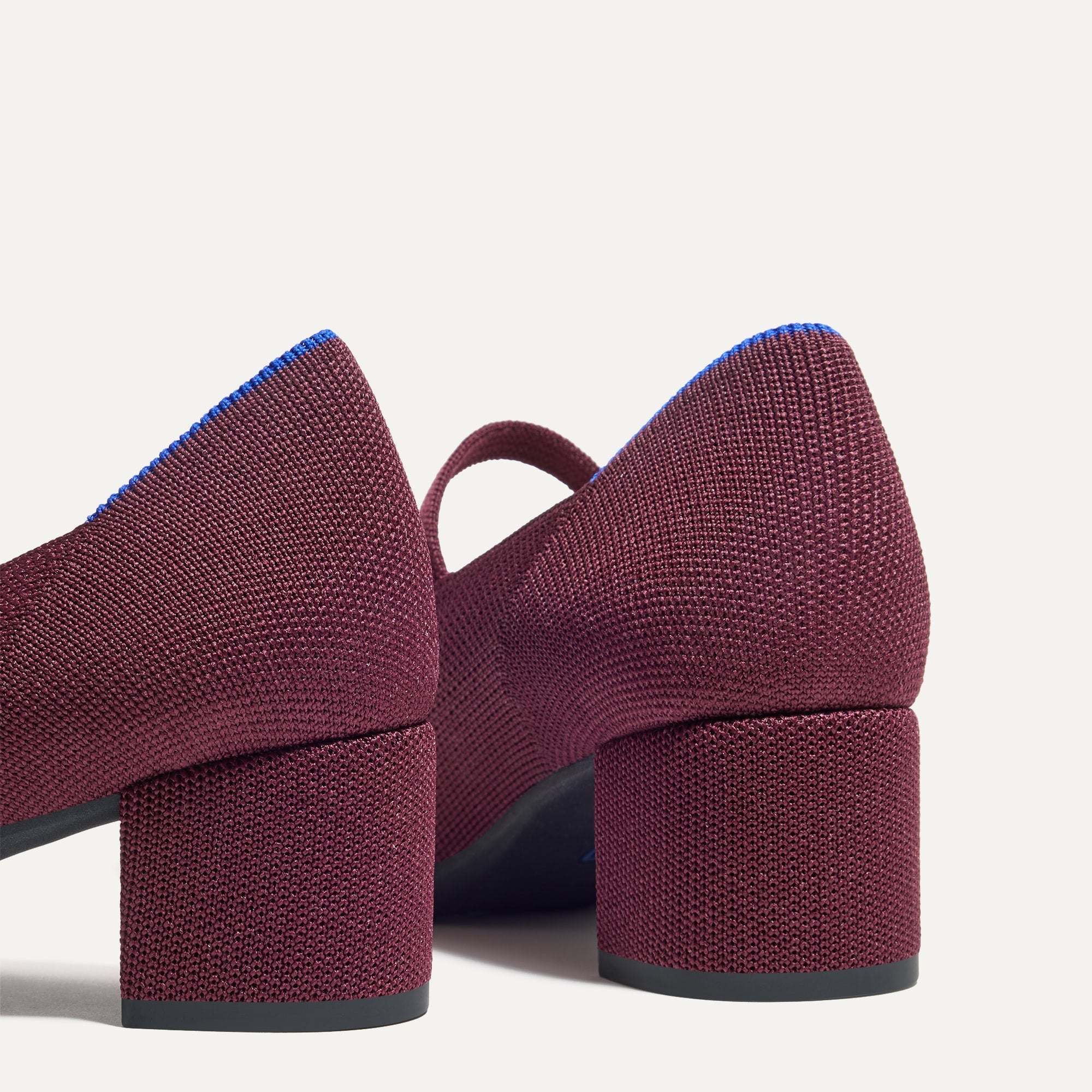 Close up of the heel of The Mary Jane Heel in Wine Red, with Rothy's signature blue halo.
