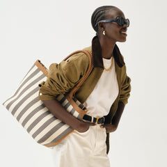 hover | Model holding The Lightweight Zip Tote in Cabana Stripe.