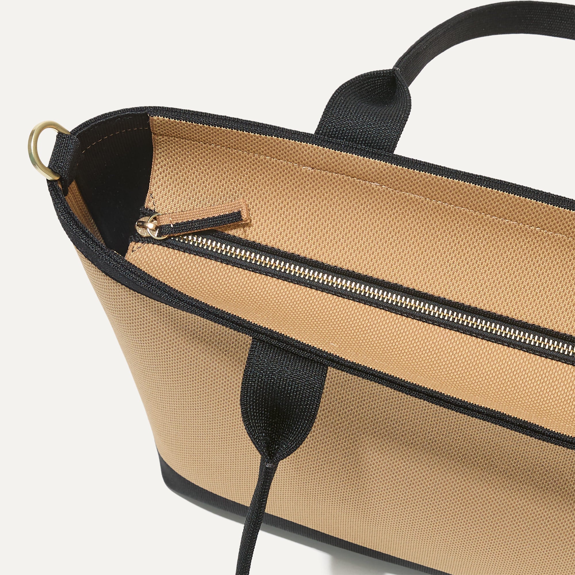 A close up of The Lightweight Zip Tote in Shortbread focusing on the zip closure and handles.