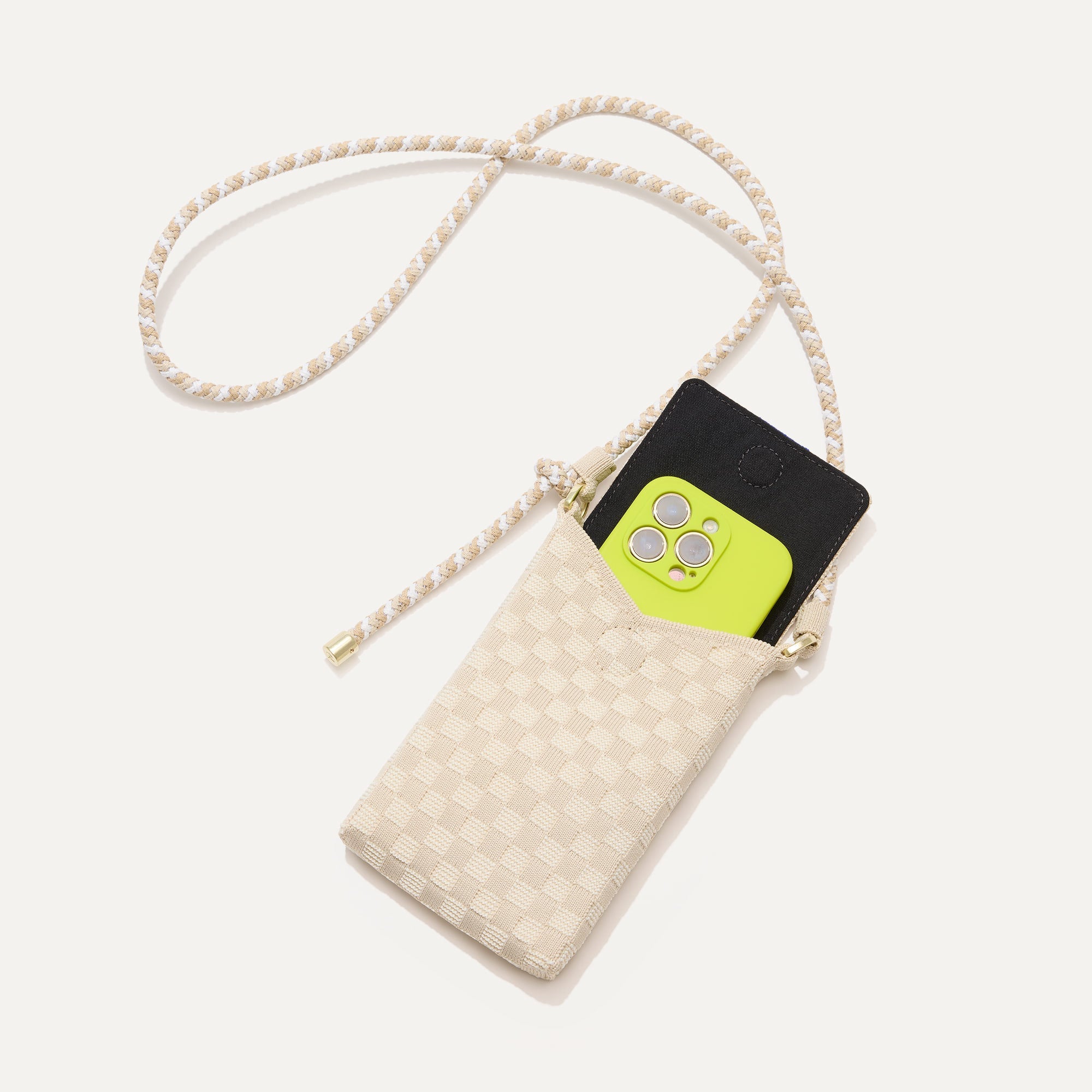 The Phone Crossbody in White Sand shown from above with an iPhone inside.