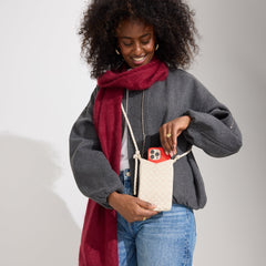 An alternate view of a model wearing The Phone Crossbody in White Sand.