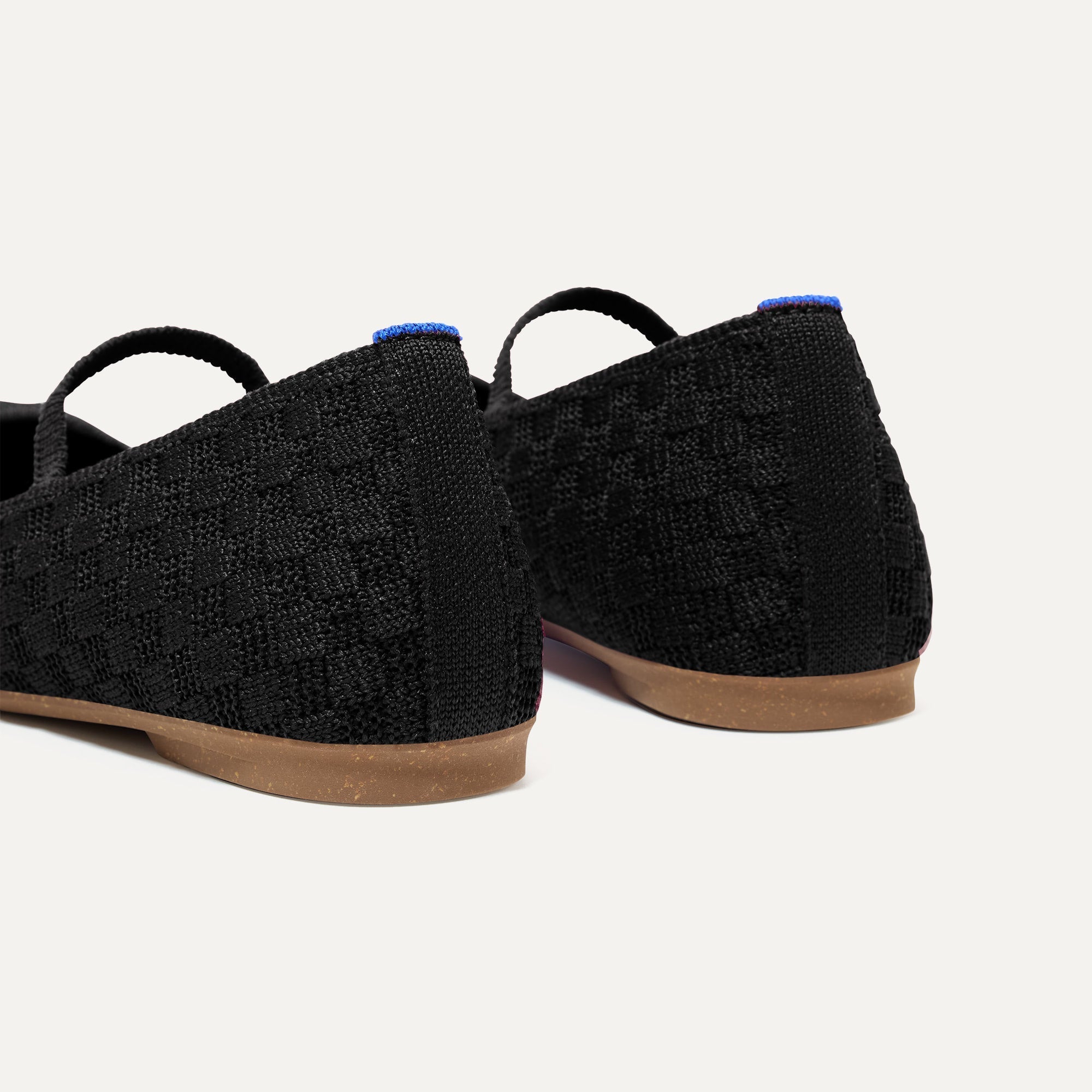 Close up of the heel of The Max Square Mary Jane in Black Sand, with Rothy's signature blue halo.