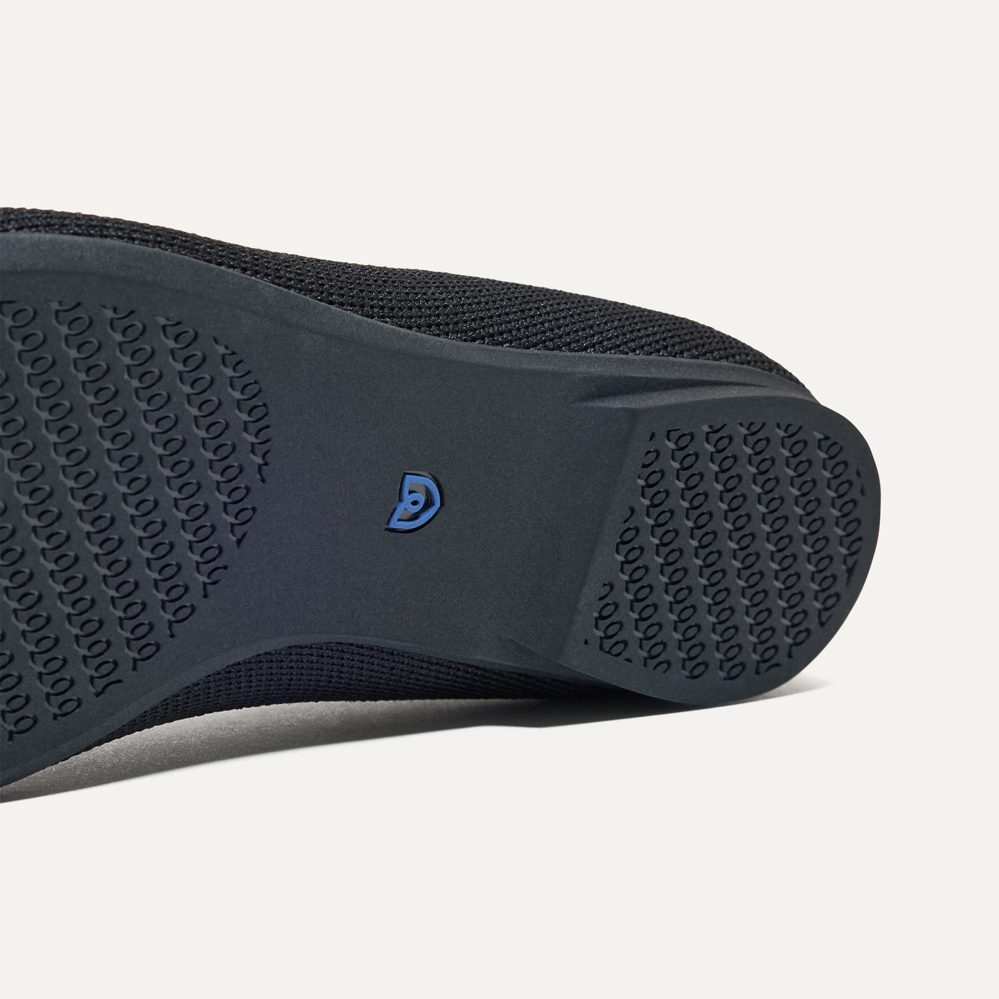 The sole of The Max Square Mary Jane in Black shown in diagonal view.