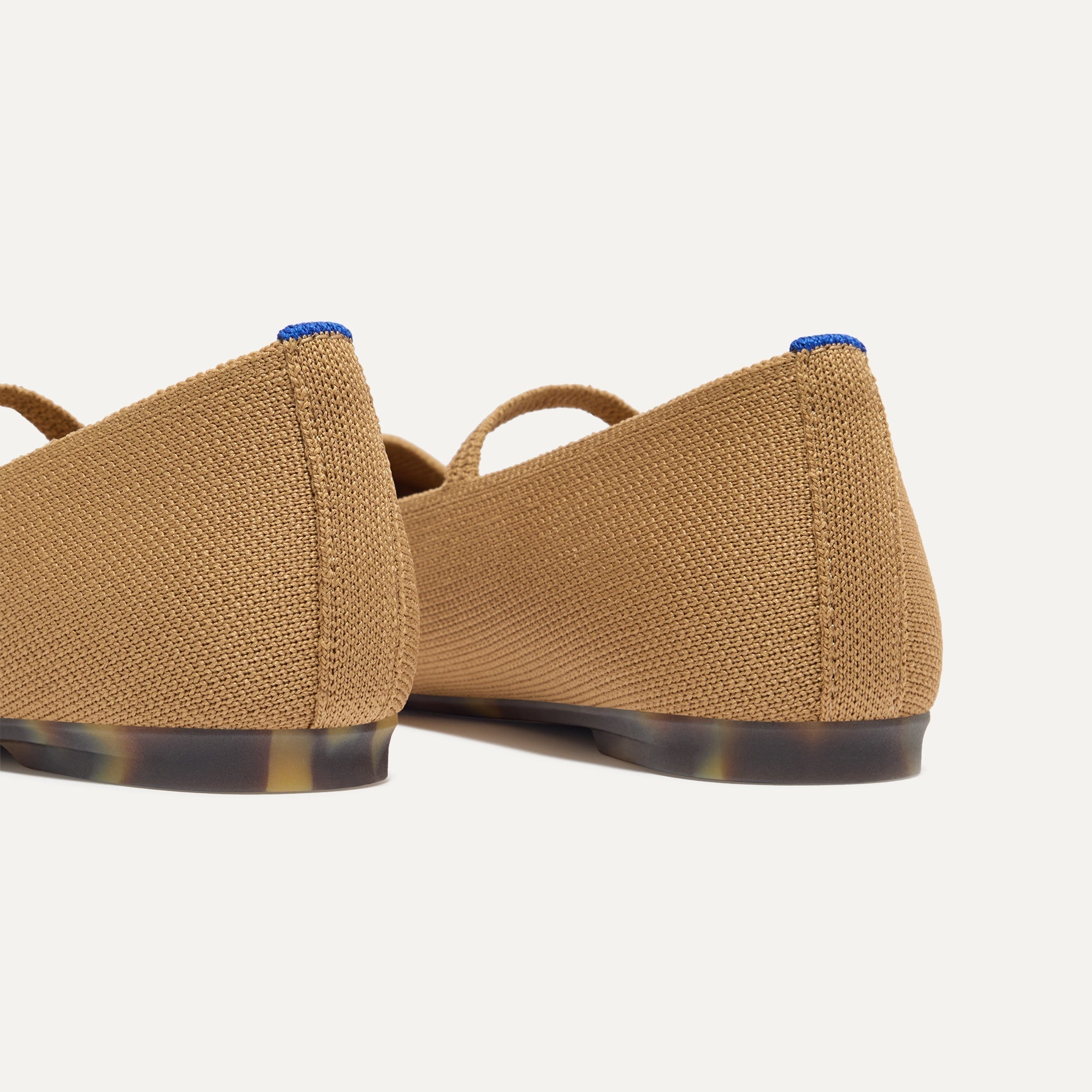 Close up of the heel of The Max Square Mary Jane in Wren, with Rothy's signature blue halo.