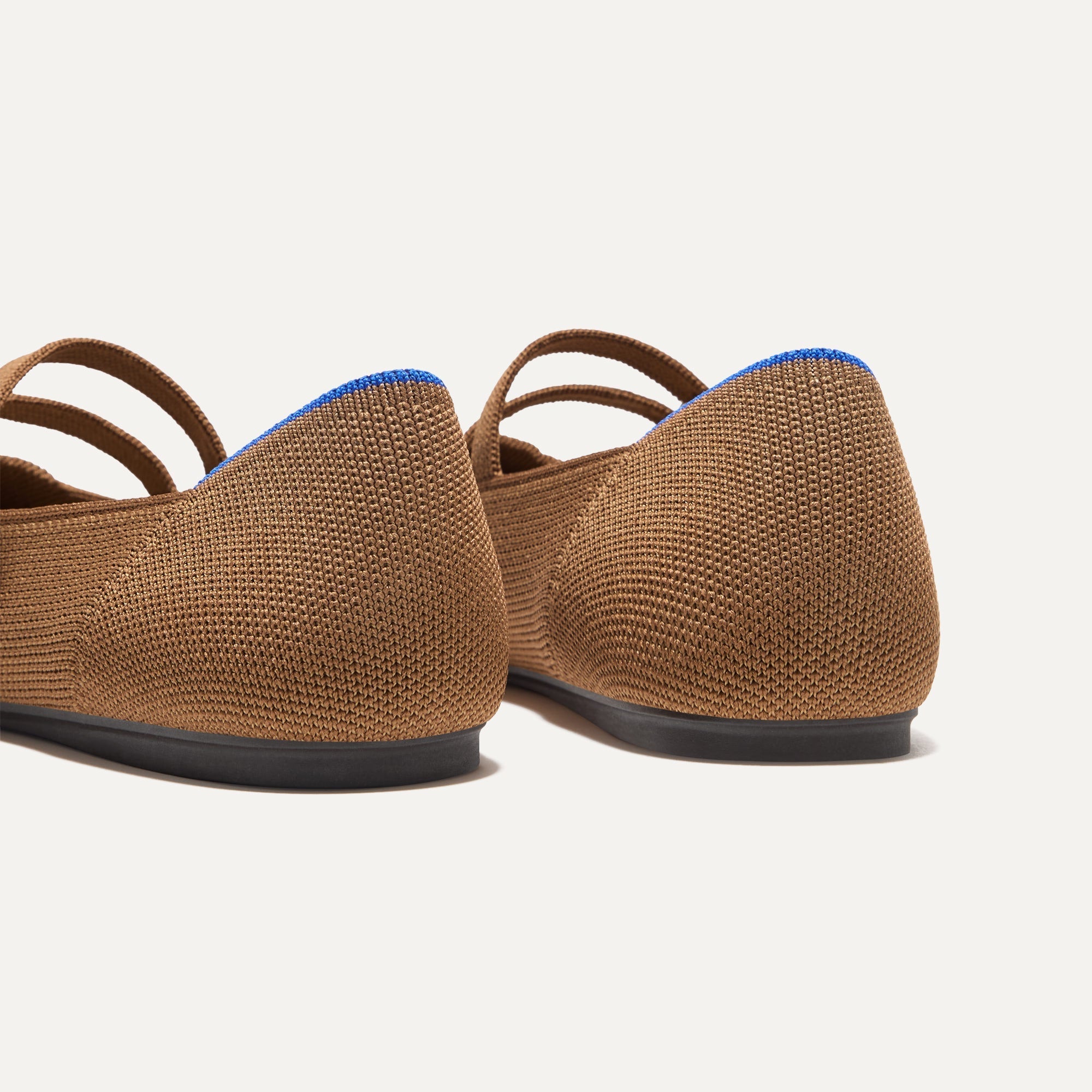 Close up of the heel of The Double Buckle Mary Jane in Java Chip, with Rothy's signature blue halo.