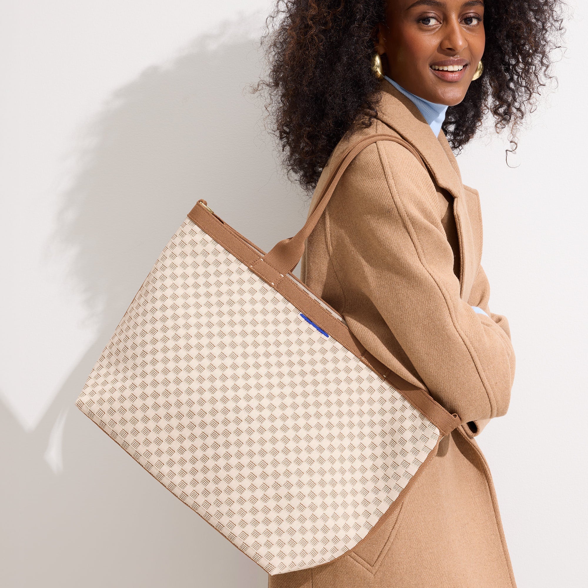 hover | Model holding The Lightweight Zip Tote in Vanilla Wafer.