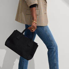 hover | The Classic Handbag in Black shown on model.