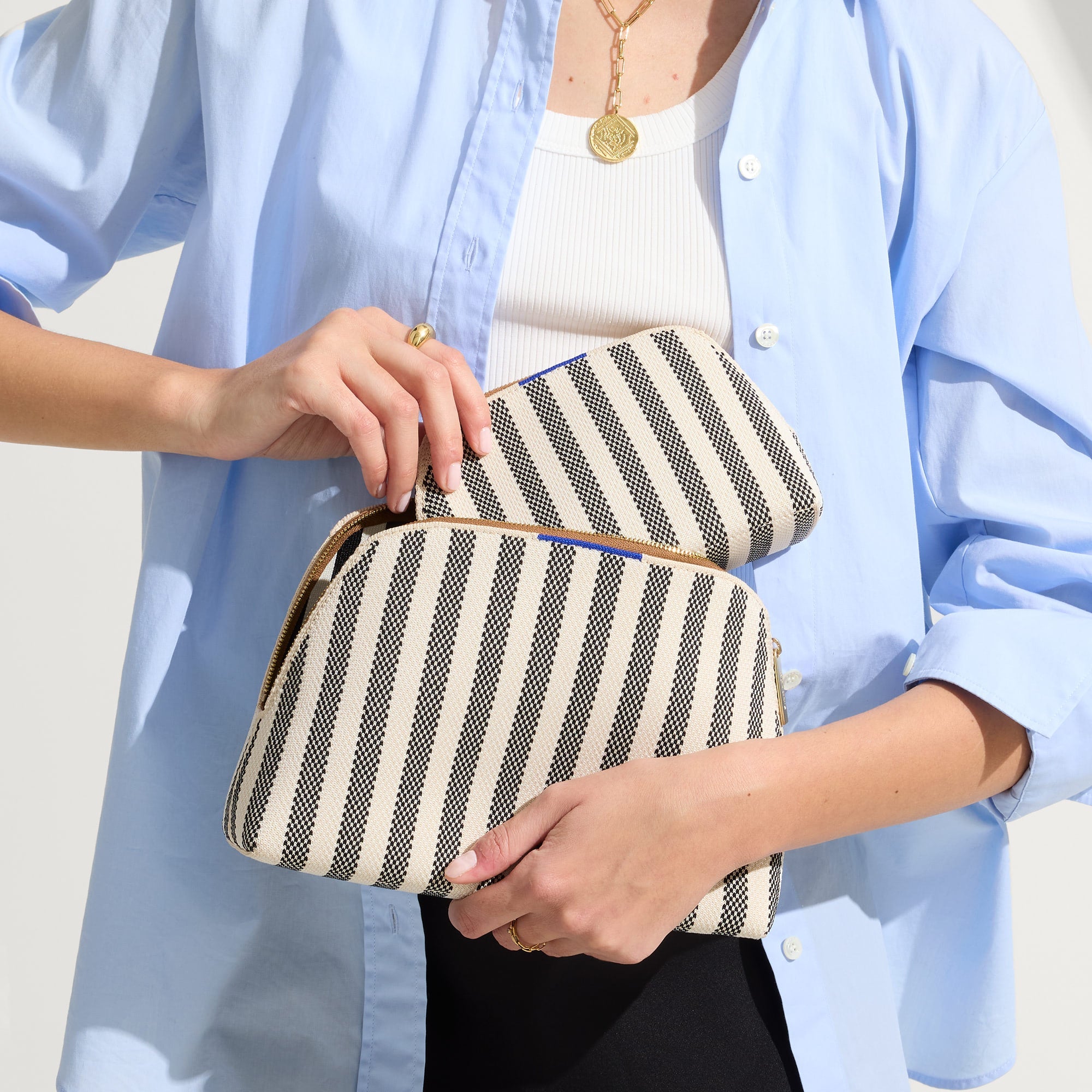 hover | Model shown holding the large and small pouch of The Vanity Set in Cabana Stripe.