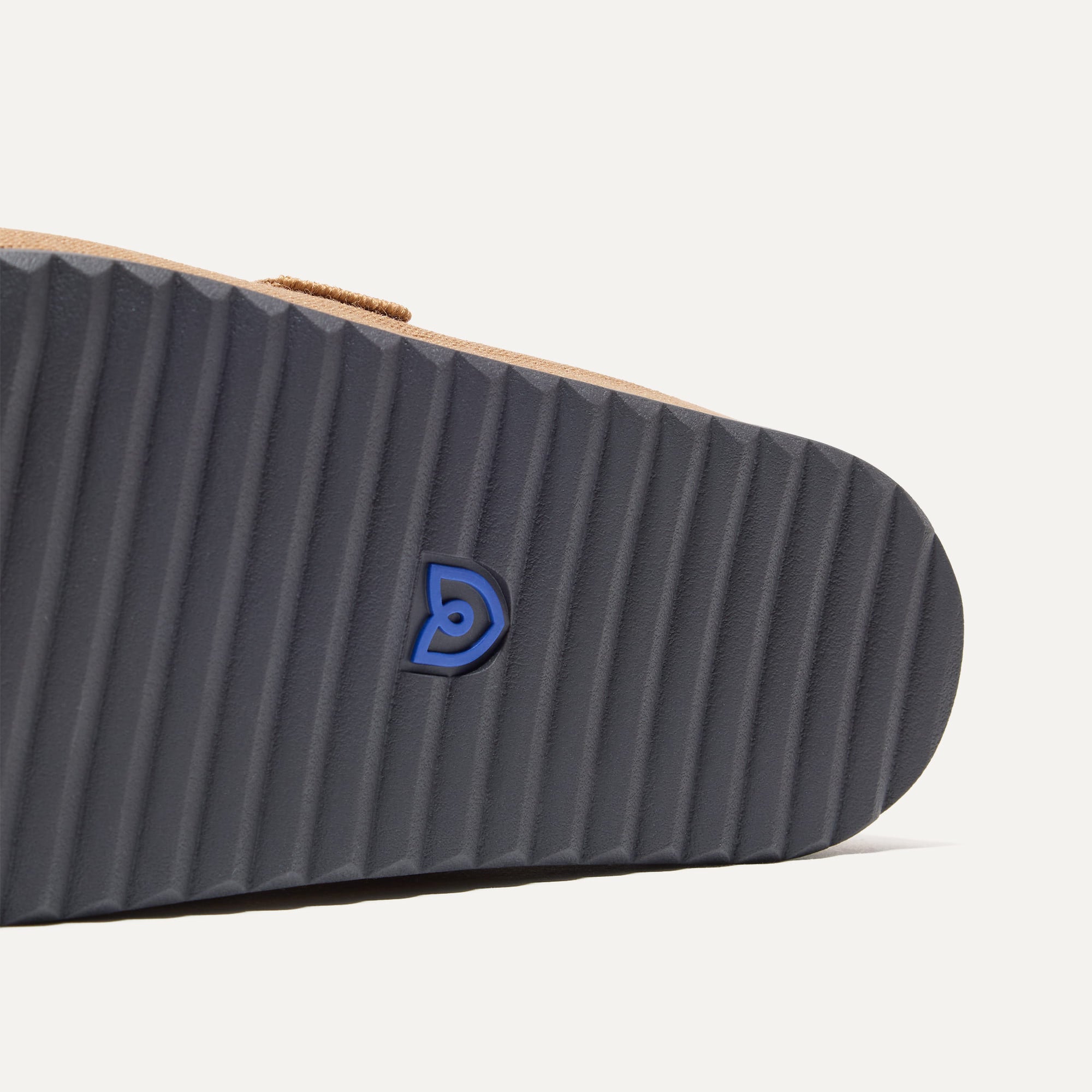 Close up of the outsoles of The Men's Clog in Butternut.