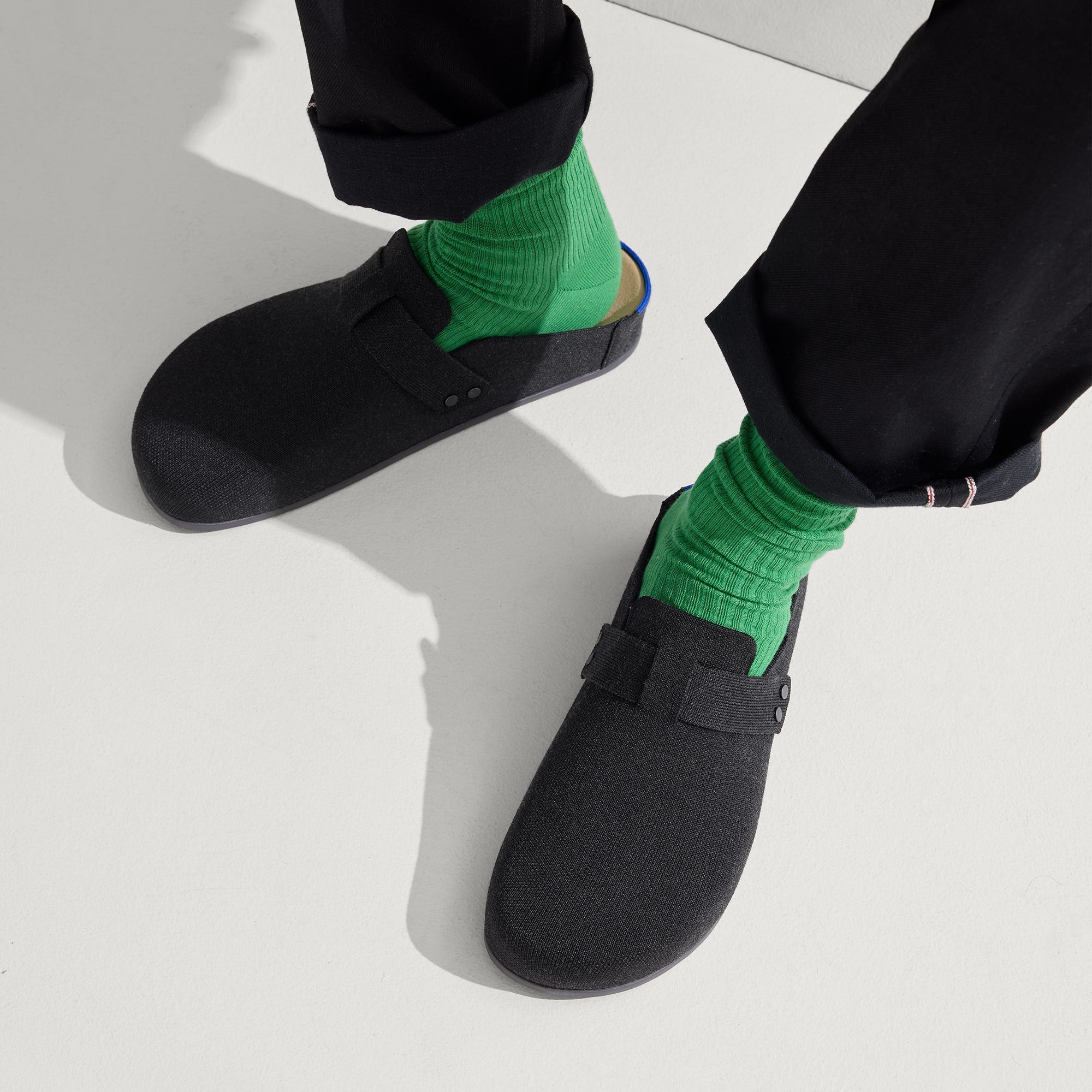 hover | Model wearing The Men's Clog in Soft Black.