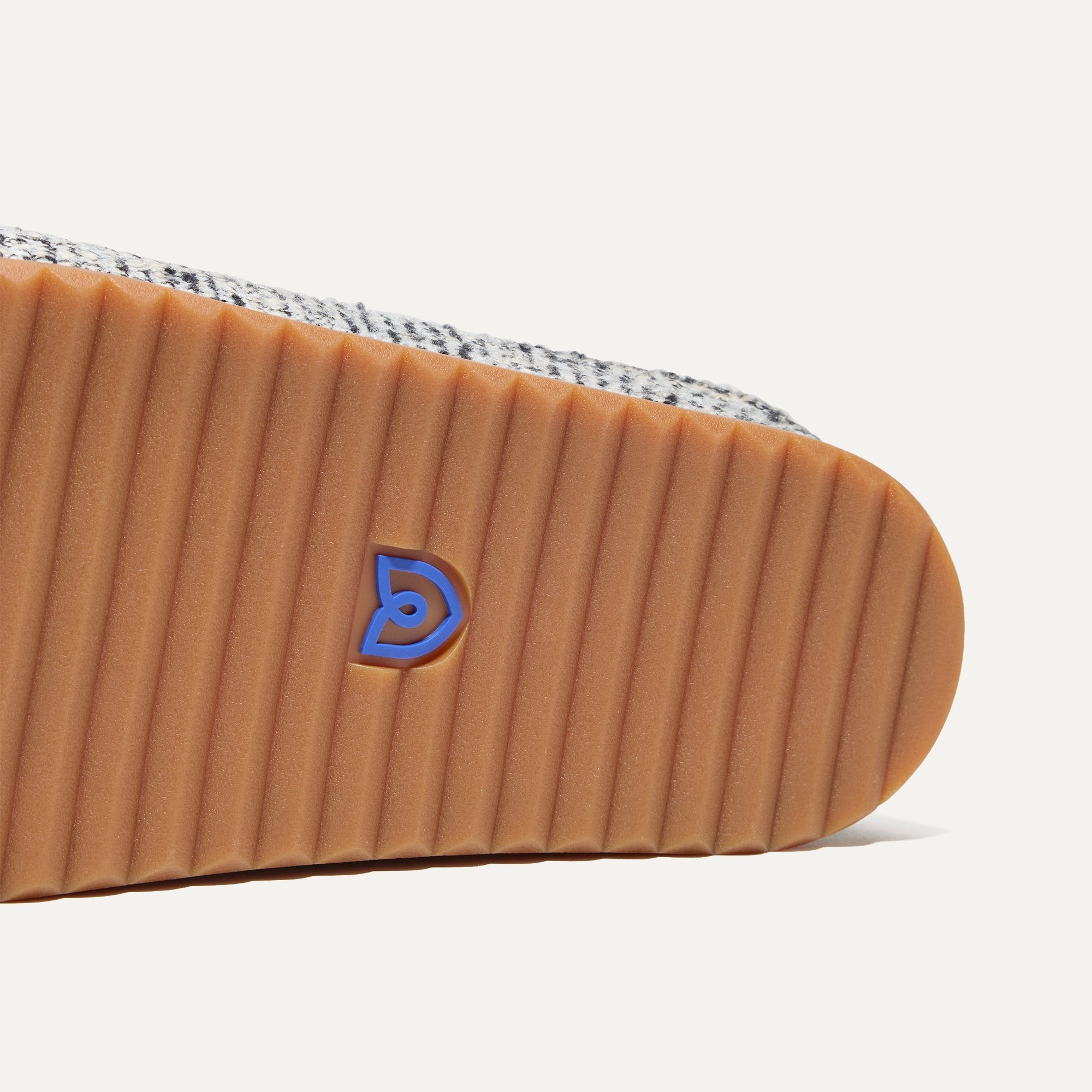 Close up of the outsoles of The Cozy Clog in Cookies and Cream Bouclé.