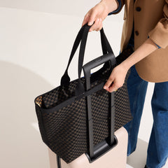 hover | Model holding The Zip Travel Tote in Night Song.