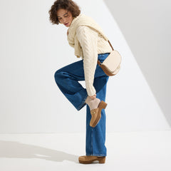 The Saddle Bag in Flat White shown on a model in an alternate view.