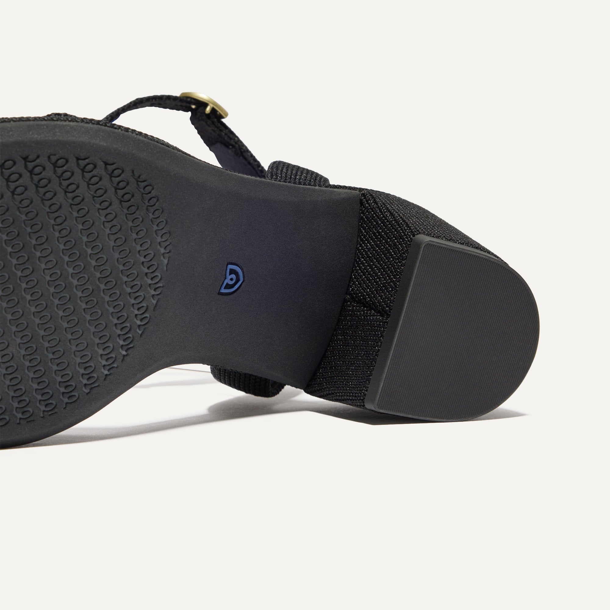 Close up of the outsoles of The Knot Sandal in Black.