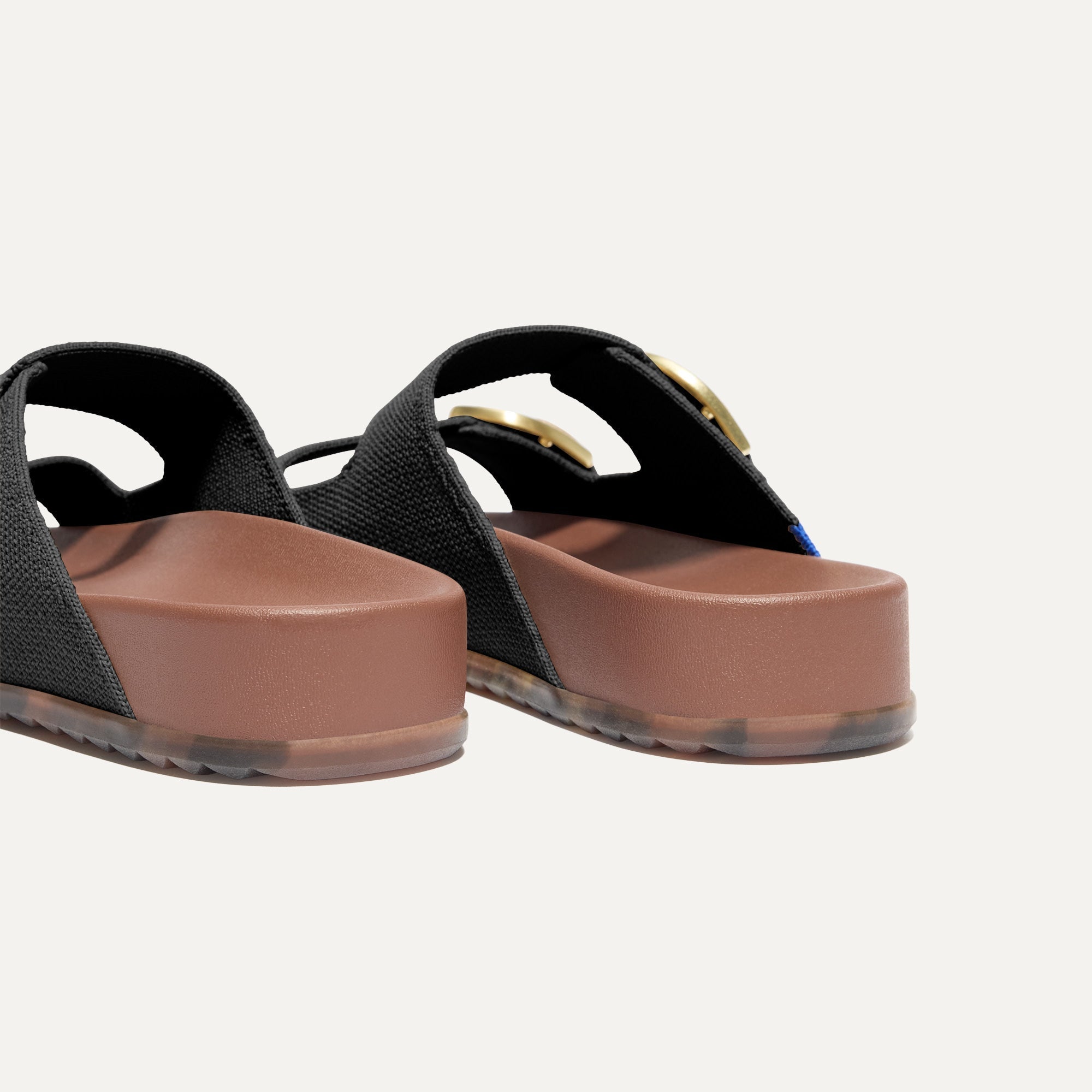 Close up of the heel of The Buckle Slide Sandal in Black.