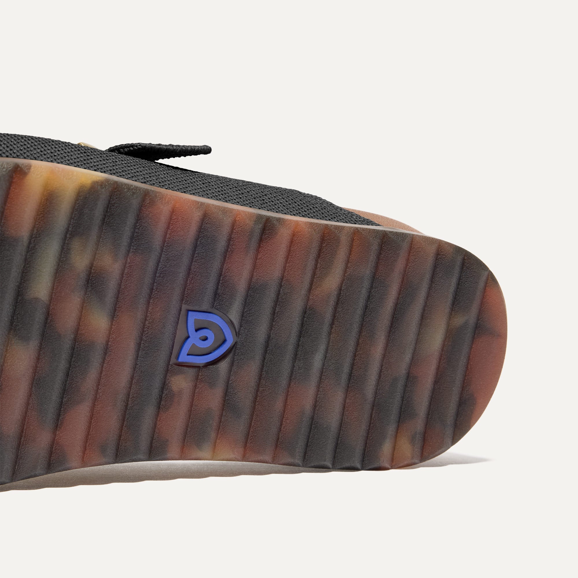 Close up of the outsole of The Buckle Slide Sandal in Black.