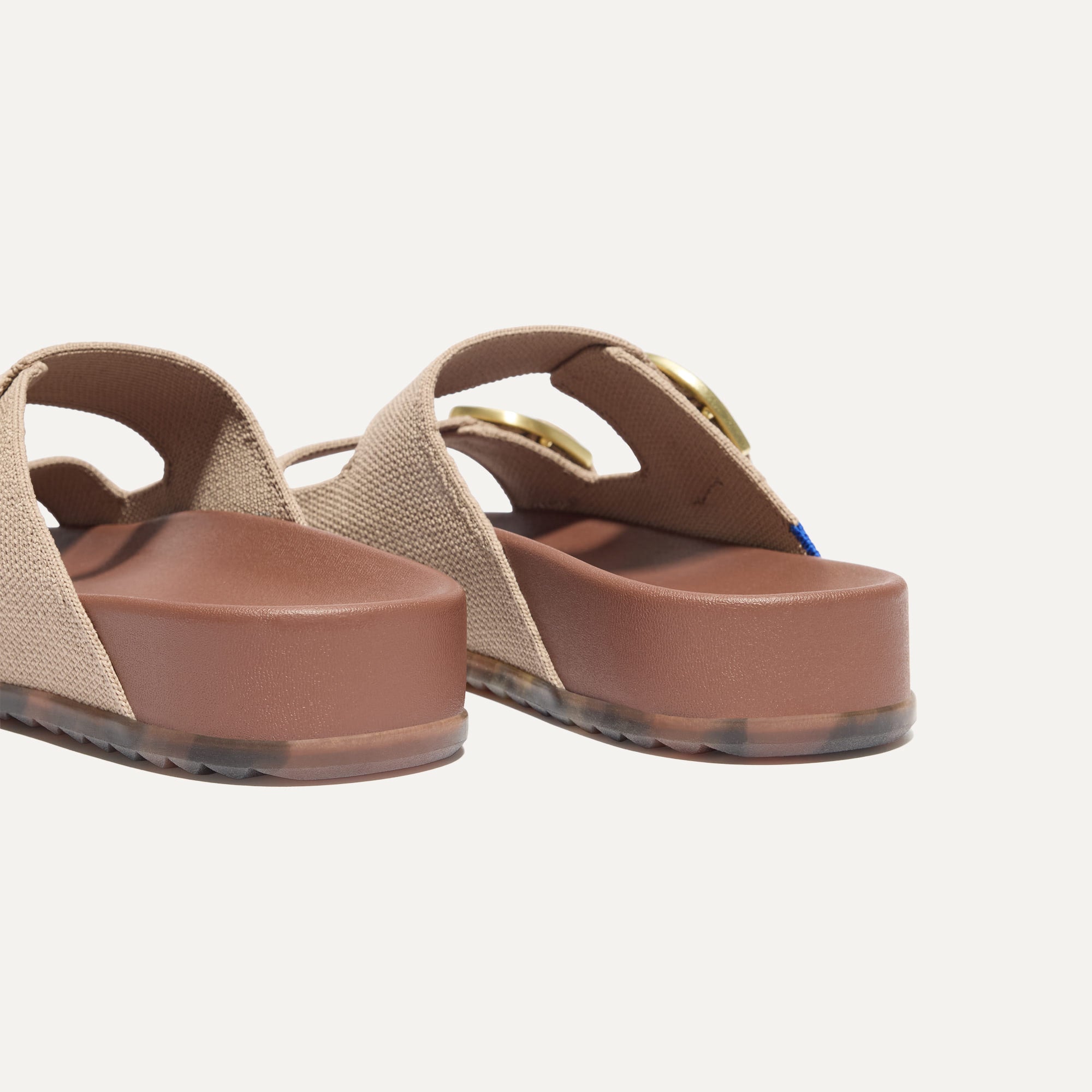 Close up of the heel of The Buckle Slide Sandal in Dune.