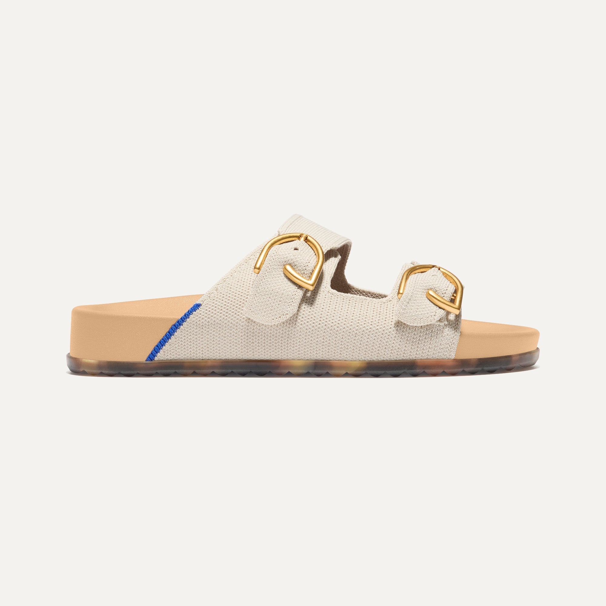 The Buckle Slide Sandal in Sea Salt  shown from the side.