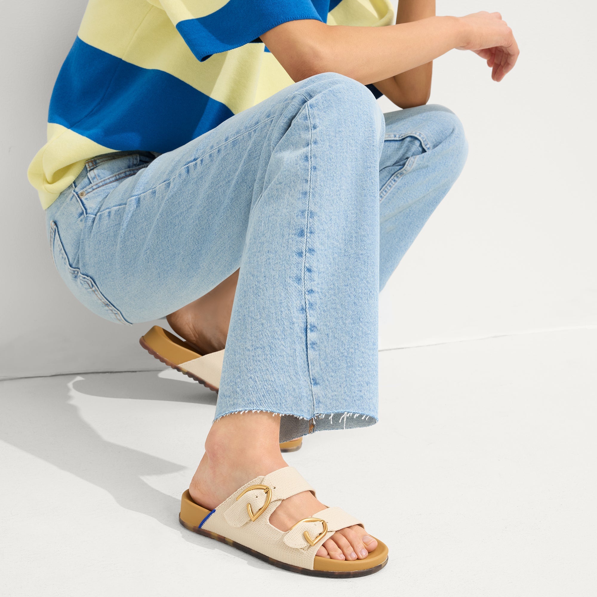 hover | Model wearing The Buckle Slide Sandal in Sea Salt