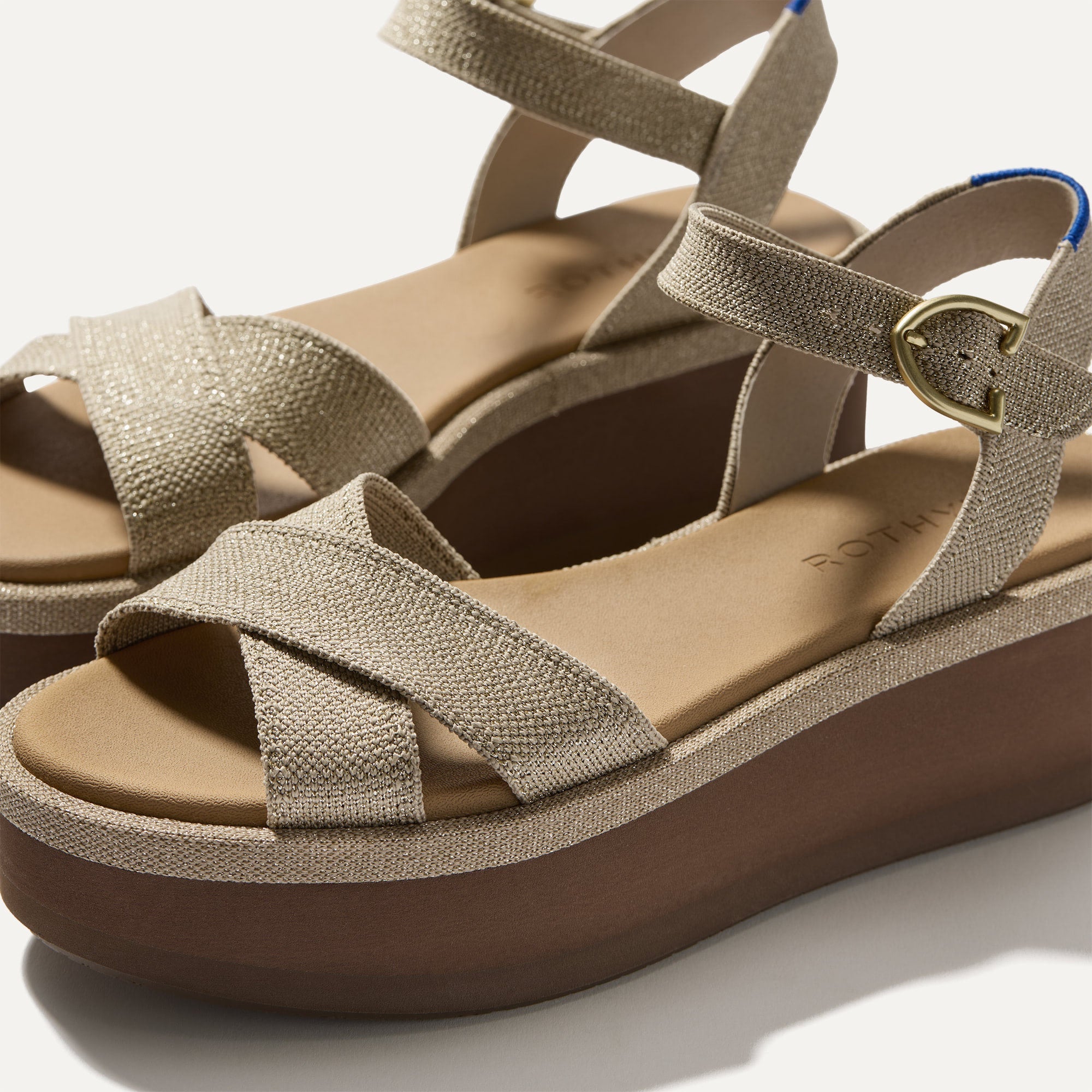Close up of the straps of The Criss-Cross Lightweight Wedge Sandal in Aurora, in diagonal view. 