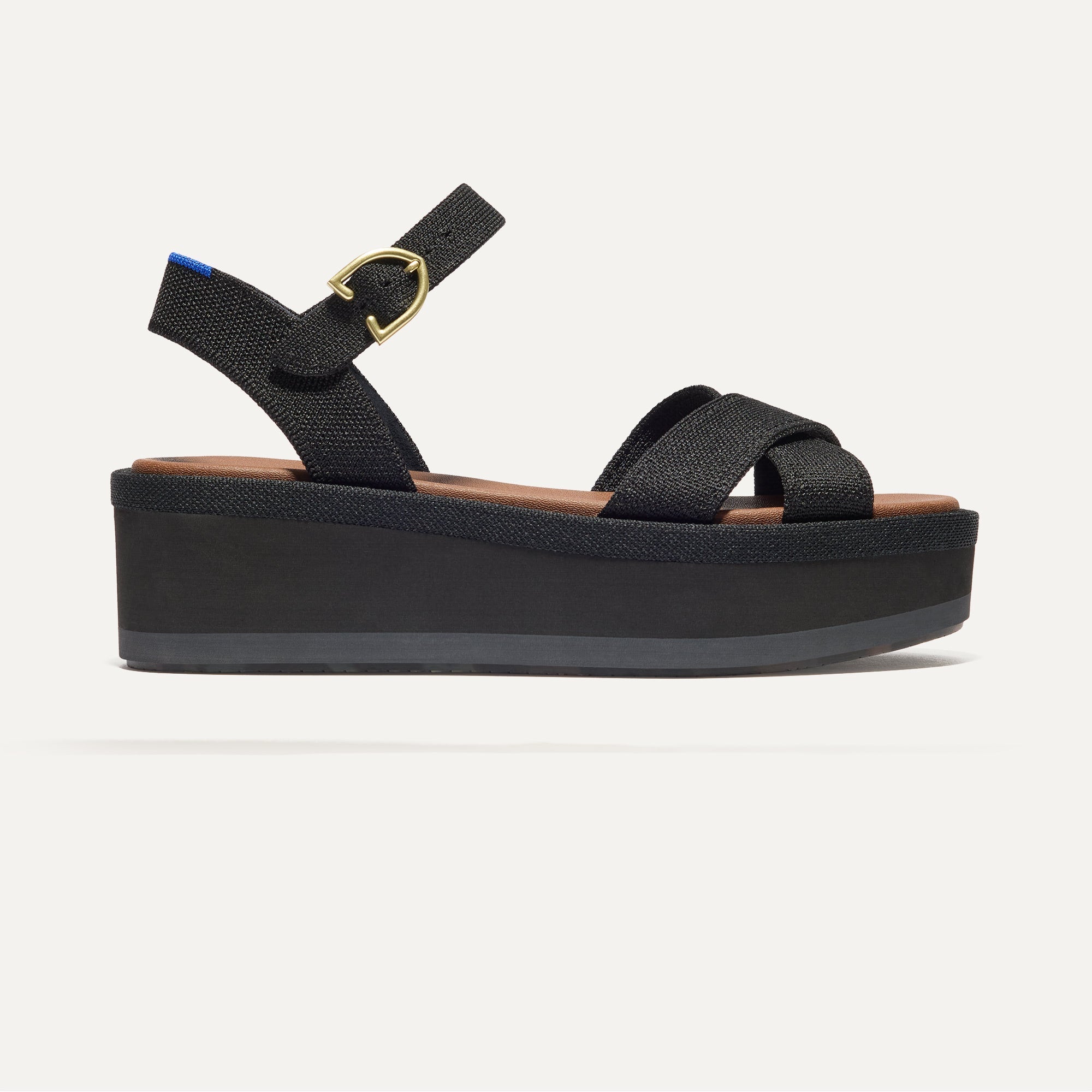 The Criss-Cross Lightweight Wedge Sandal in Black shown from the side.
